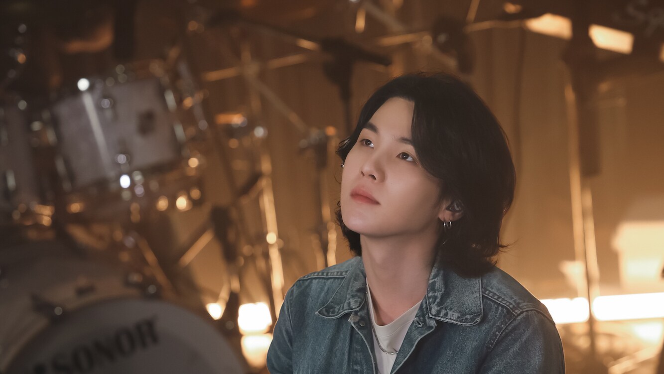 In “SUGA: Road to D-DAY,” viewers will see the BTS star searching for musical inspiration for his upcoming album D-DAY. Traveling around the world in search of musical inspiration, SUGA will be at his most vulnerable as he discusses his writer’s block with other musicians, and delves deep into his most traumatic memories to pen lyrics for several of his latest songs.