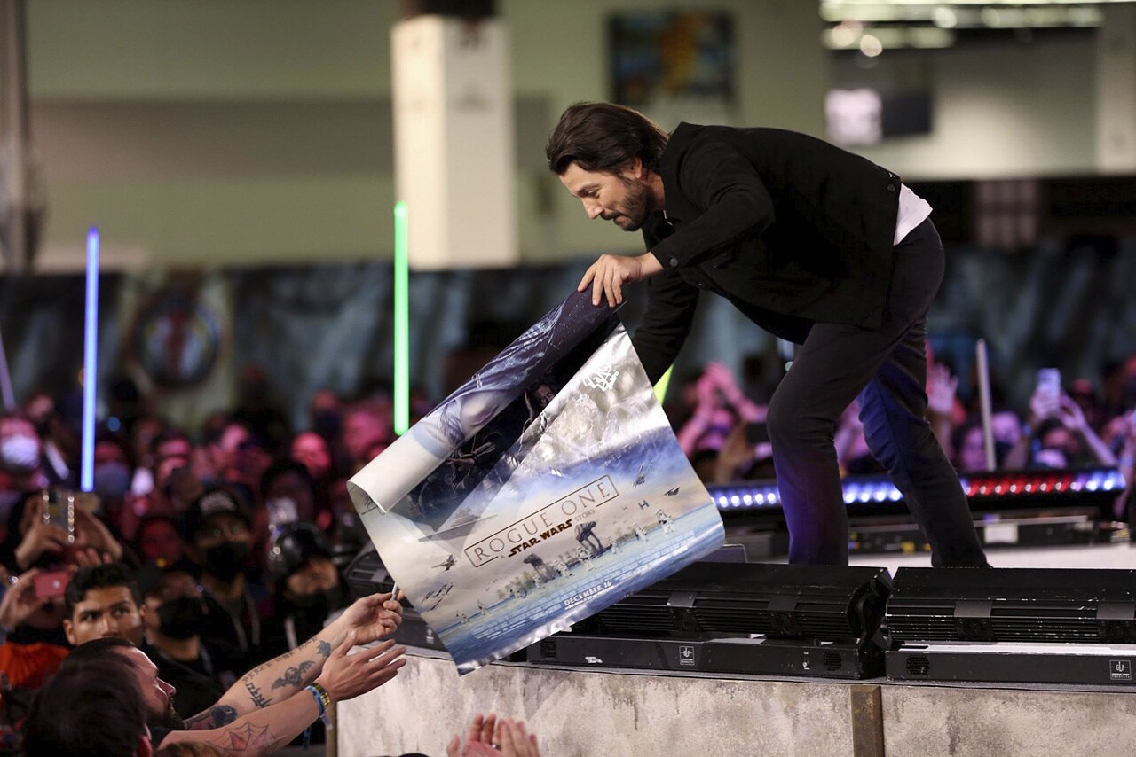 Diego Luna signing a poster
