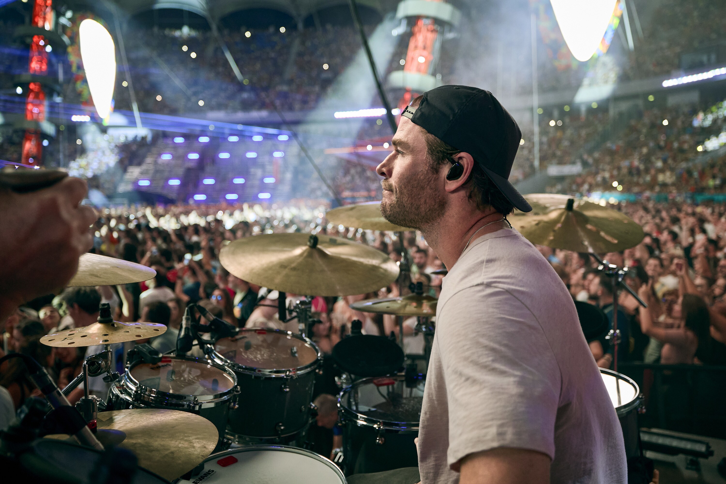 Chris Hemsworth drums during the Ed Sheeran concert in Bucharest. (credit: NationalGeographic/Evan Paterakis)