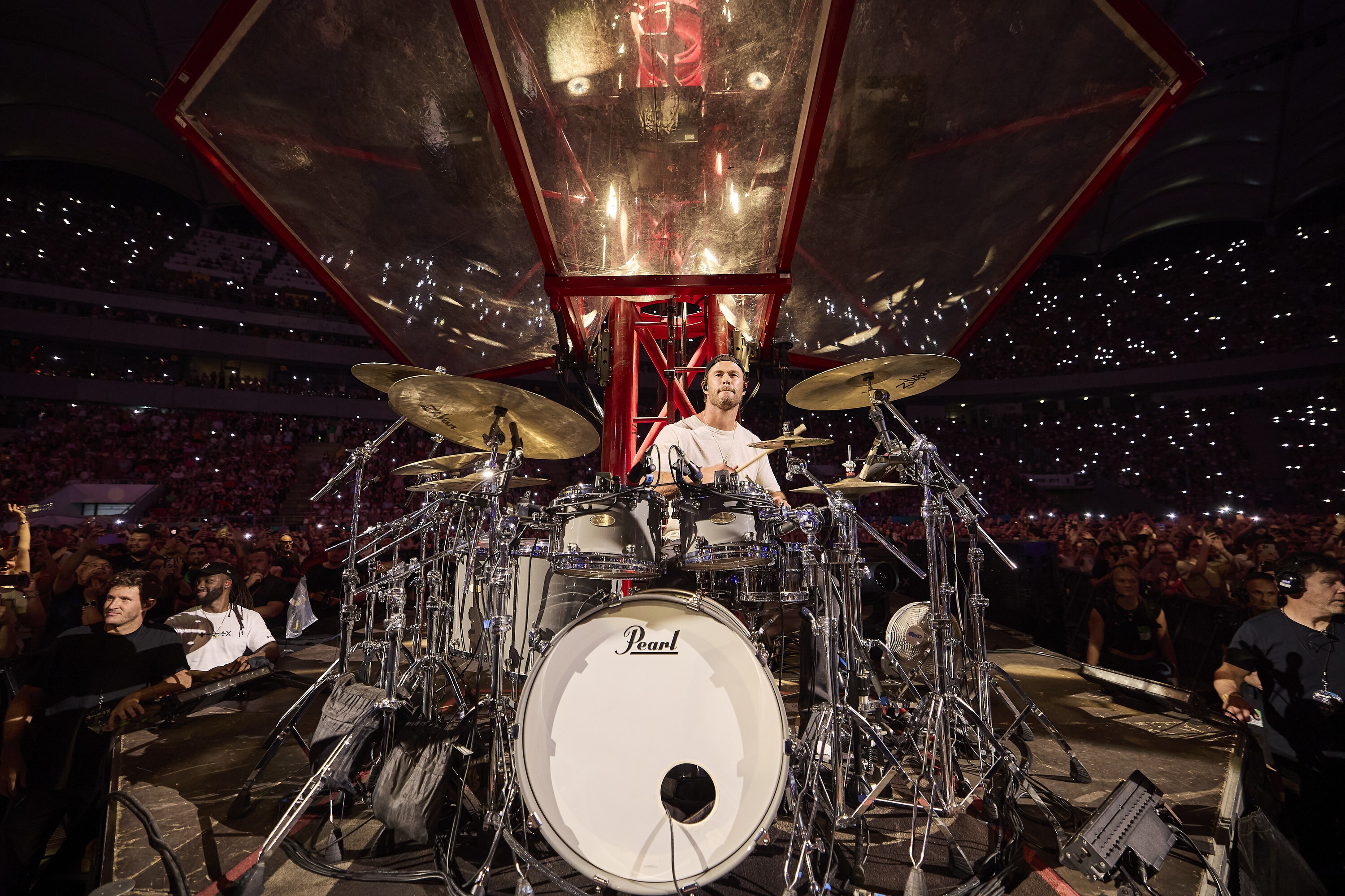 Chris Hemsworth drums during the Ed Sheeran concert in Bucharest. (credit: NationalGeographic/Evan Paterakis)