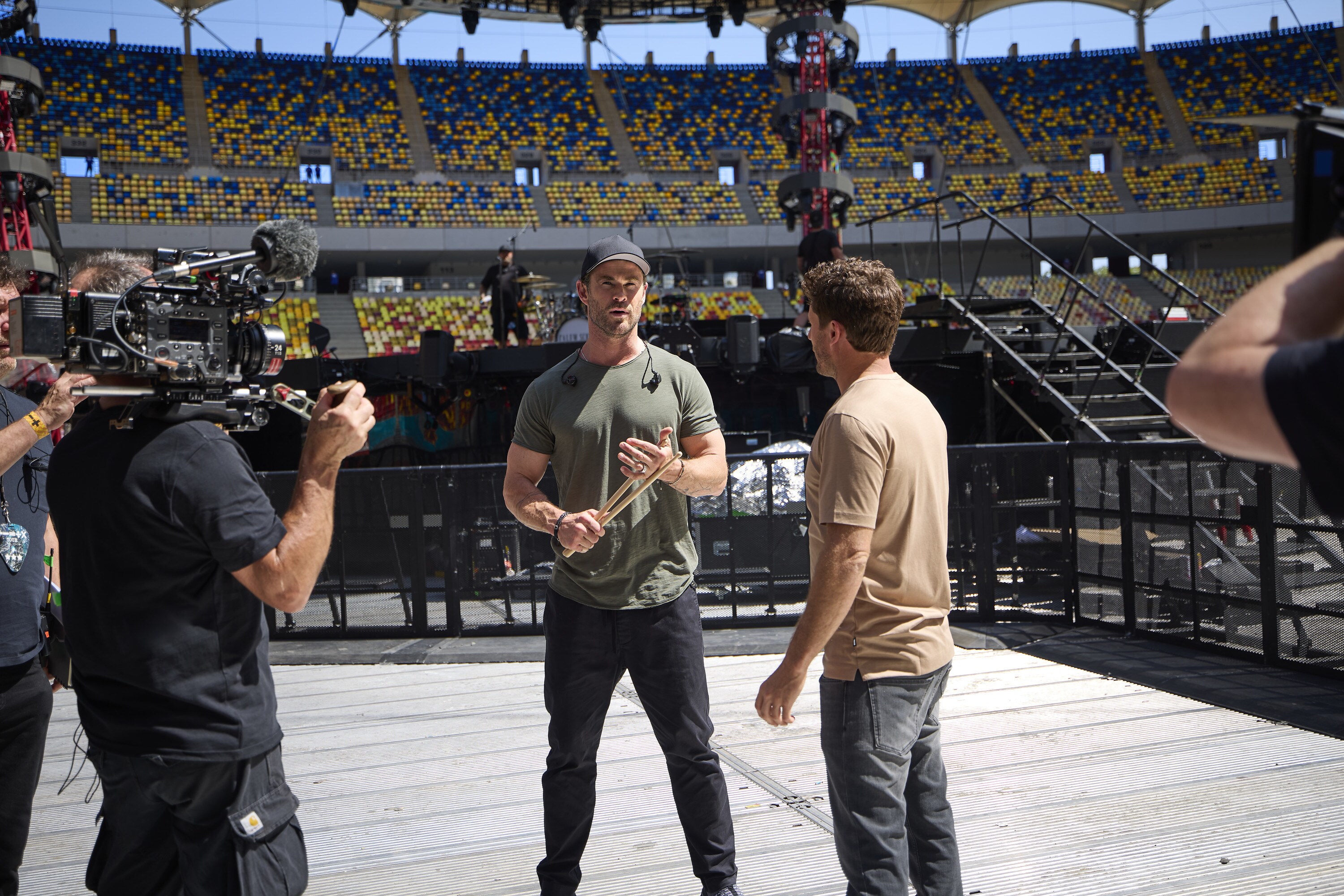 Chris Hemsworth, left, talks with Ben Gordon during a walkthrough before his concert appearance drumming for Ed Sheeran. (credit: National Geographic/EvanPaterakis)