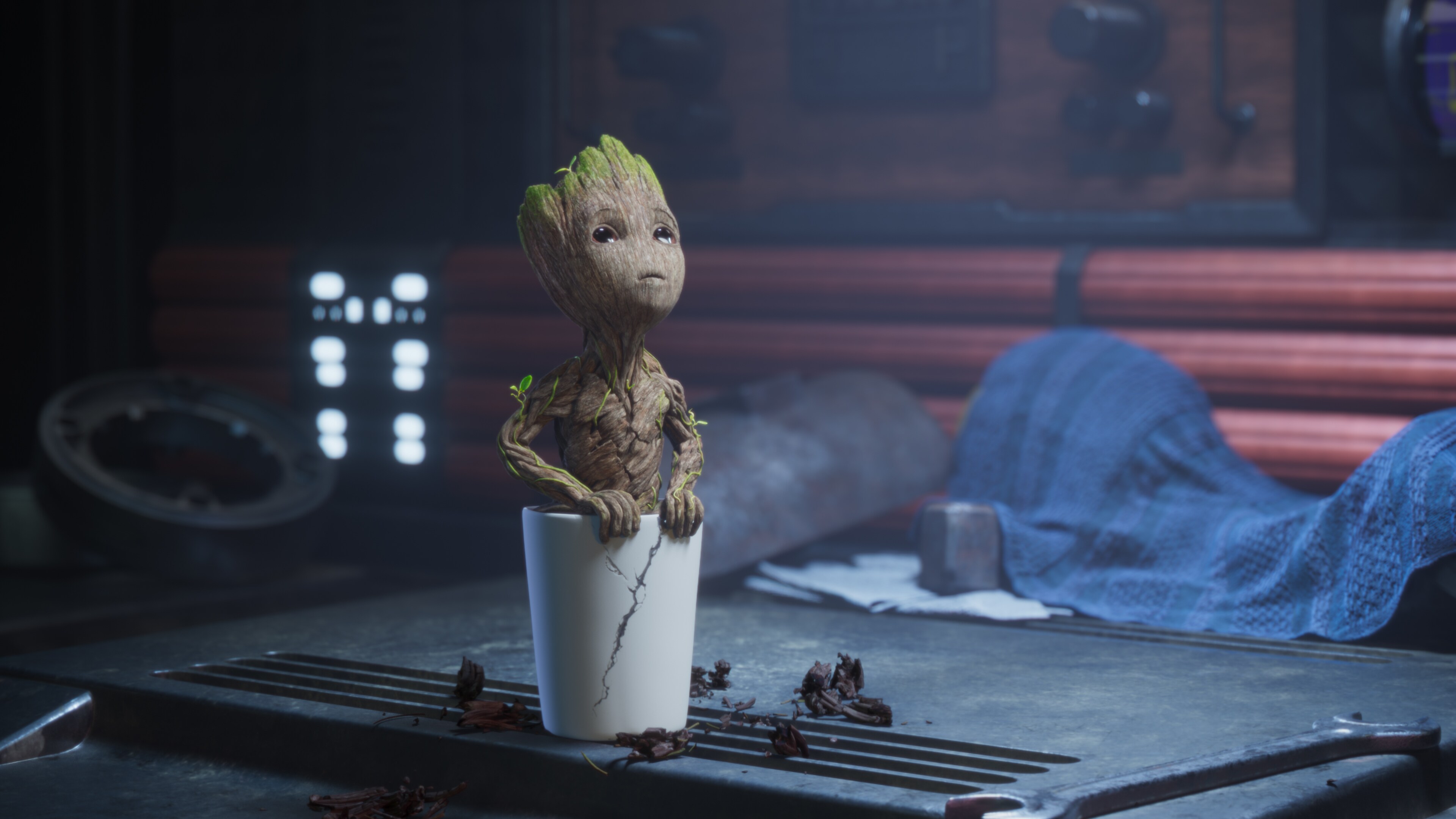 Groot in a plant pot looking up.