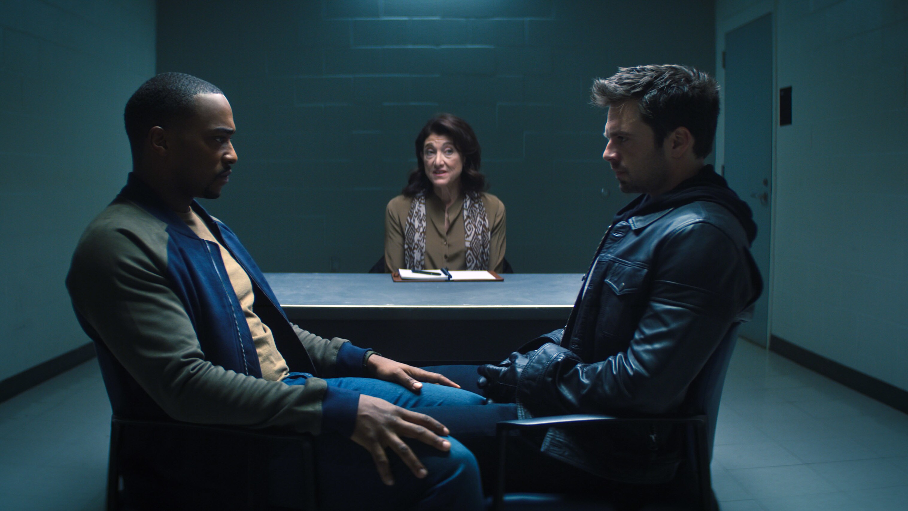 (L-R): Falcon/Sam Wilson (Anthony Mackie), therapist (Amy Aquino) and Winter Soldier/Bucky Barnes (Sebastian Stan) in Marvel Studios' THE FALCON AND THE WINTER SOLDIER exclusively on Disney+. Photo courtesy of Marvel Studios. ©Marvel Studios 2021. All Rights Reserved.