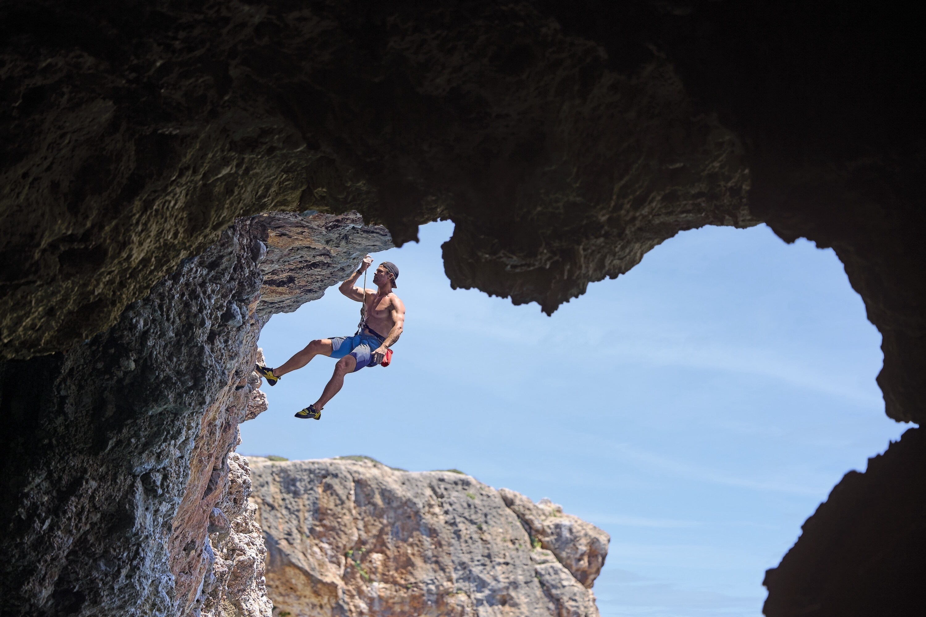 Chris recruits the help of Steph Davis, one of the best free solo climbers in the world, to train for a 'Deep Water Soloing' – no ropes, no safety equipment, just Chris climbing the rock face from the sea to the top of the cliff. This training will help prepare him for his final 600-foot climb on a wintery Swiss Alps Dam. (credit: National Geographic/Evan Paterakis)