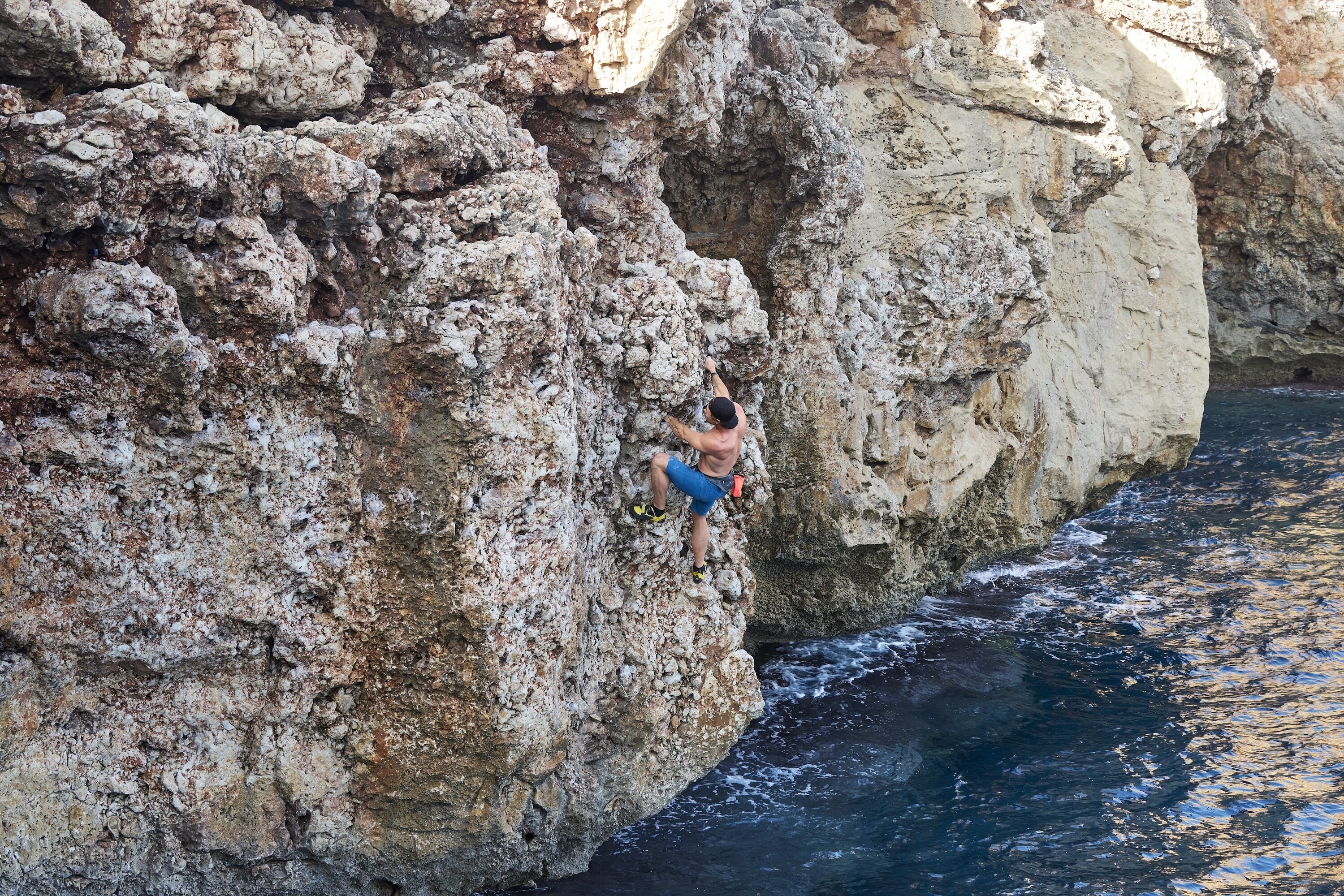 Chris recruits the help of Steph Davis, one of the best free solo climbers in the world, to train for a 'Deep Water Soloing' – no ropes, no safety equipment, just Chris climbing the rock face from the sea to the top of the cliff. This training will help prepare him for his final 600-foot climb on a wintery Swiss Alps Dam. (credit: National Geographic/Evan Paterakis)