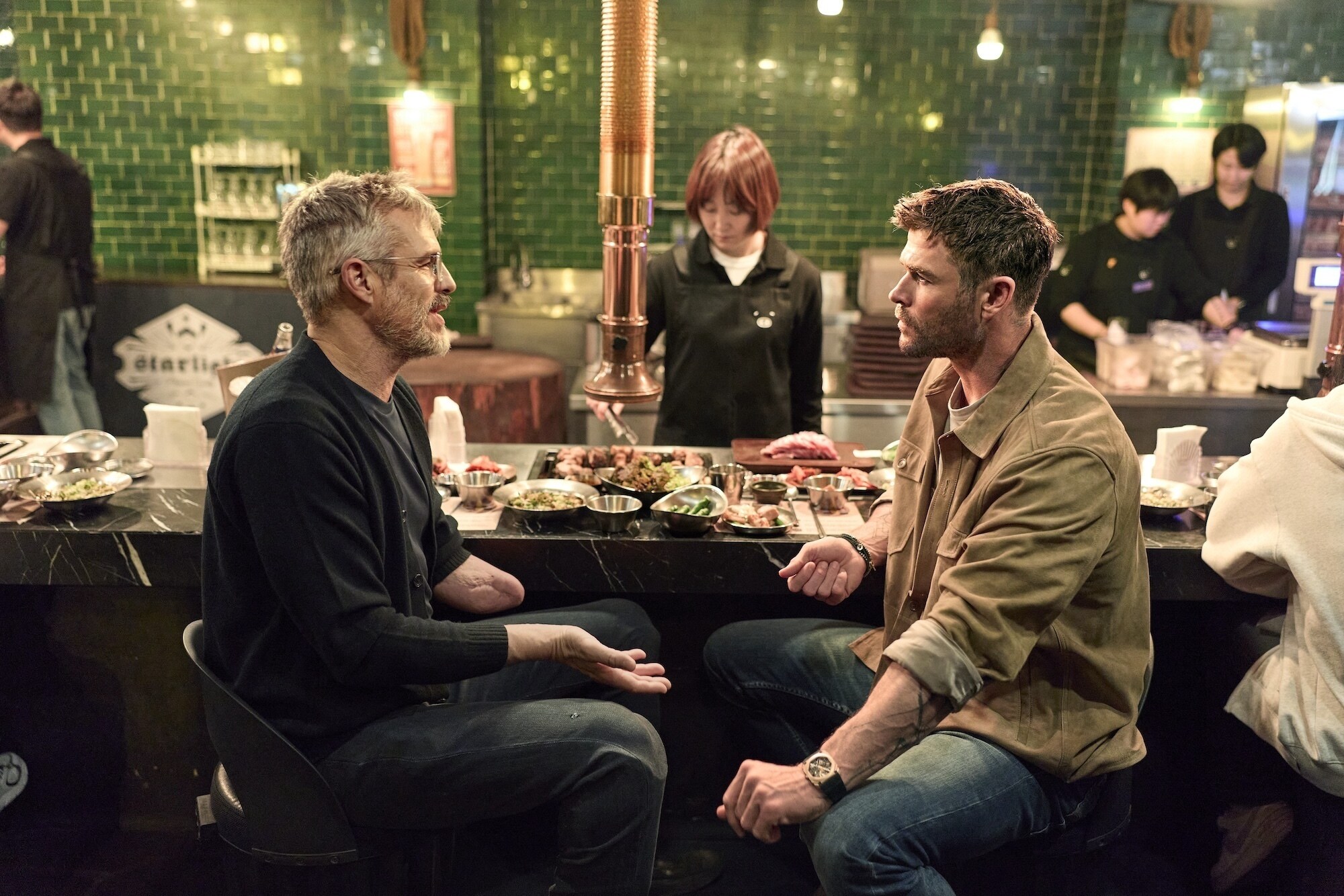 Chris Hemsworth sets out to confront his chronic pain in a bold, immersive journey through South Korea.  At a meal, Chris and Dr. B.J. Miller taste foods and discuss pain.  (credit: National Geographic/Evan Paterakis)