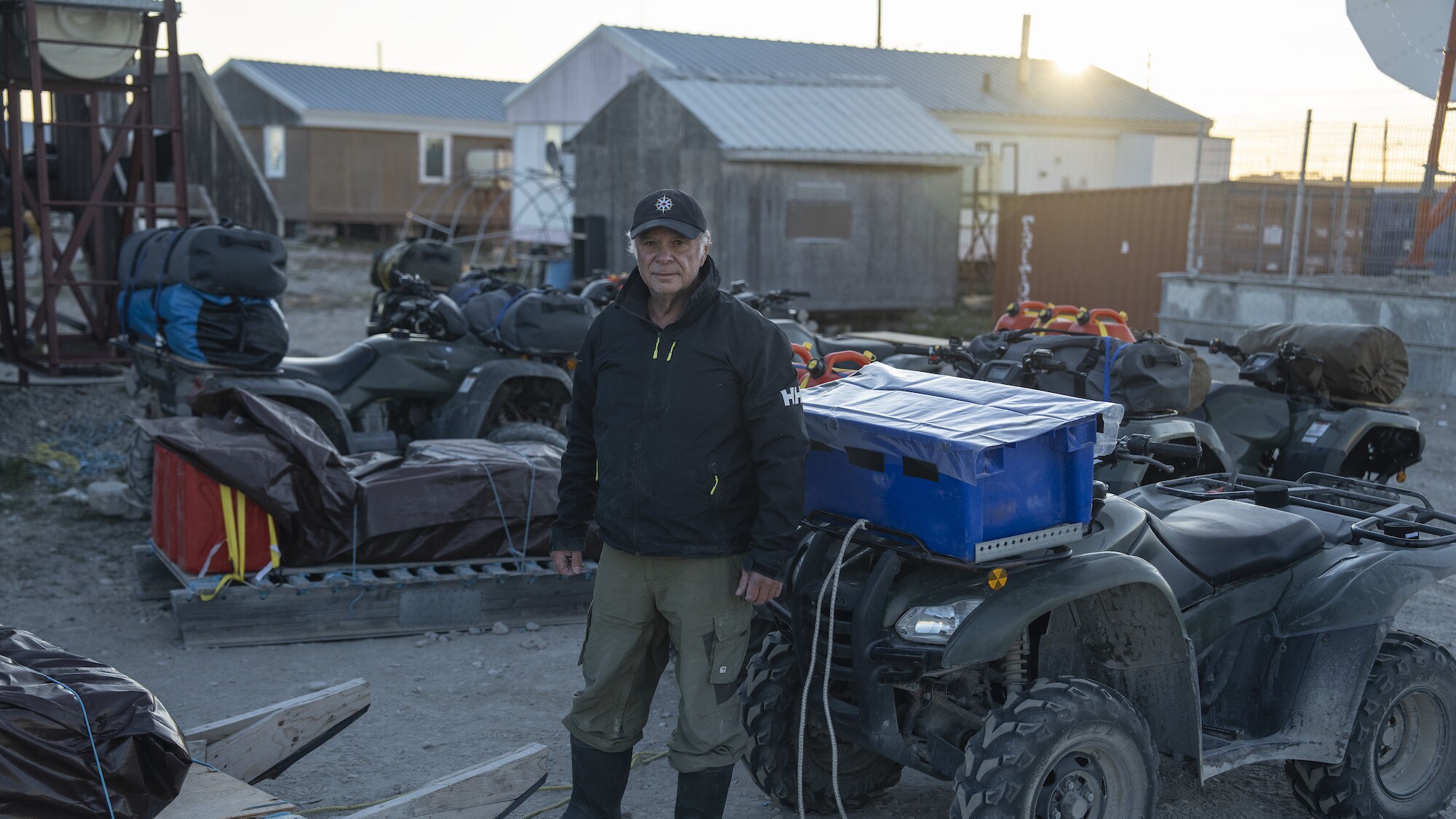 Franklin historian Tom Gross stands among ATVs in Gjoa Haven, Nunavut, Canada. He is preparing to journey across King William Island to in search of Sir John Franklin's lost tomb. (National Geographic/Renan Ozturk)