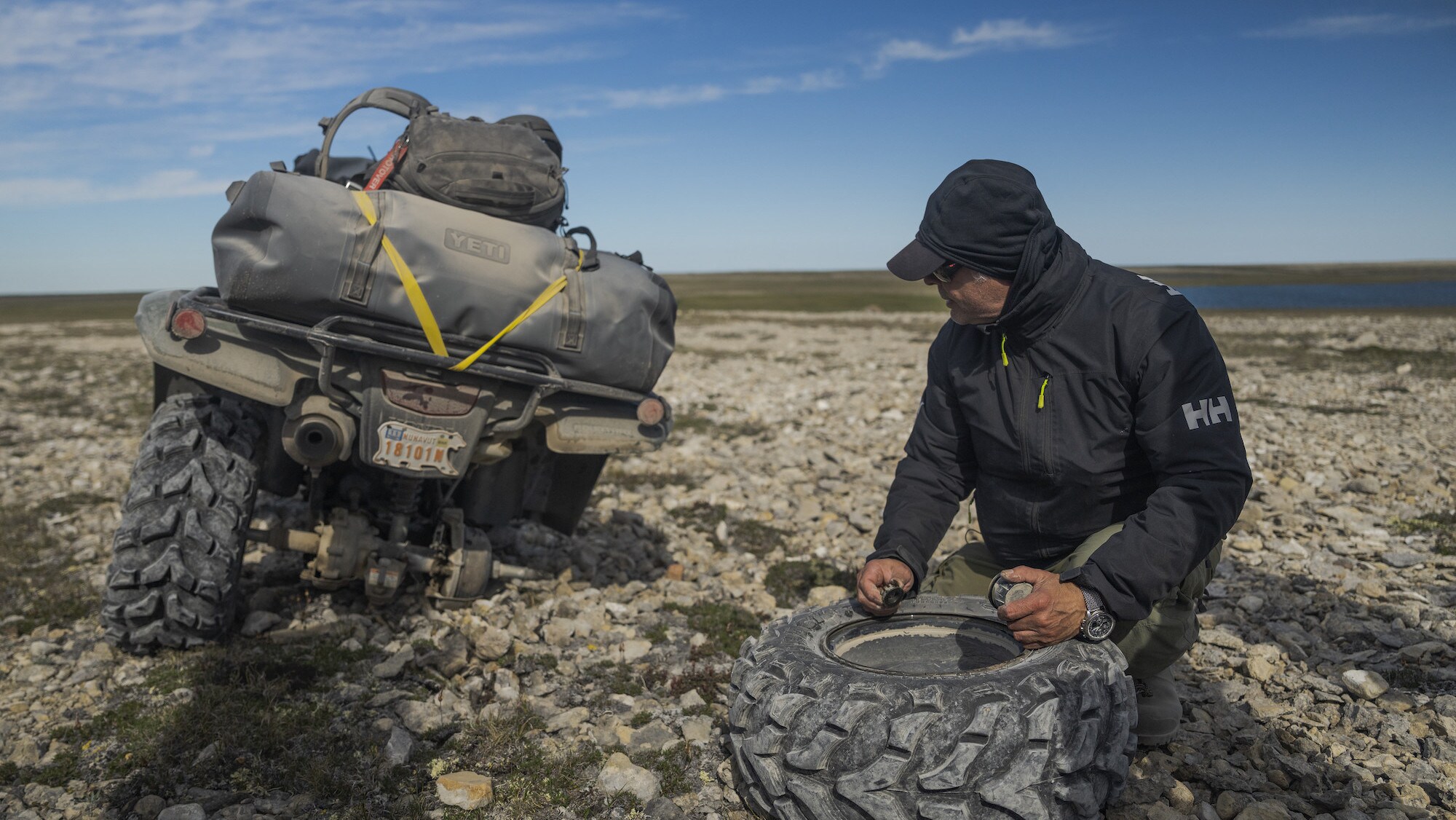 Franklin historian Tom Gross fixes a broken tire on one of the ATVs during the journey in search of Sir John Franklin's lost tomb on King William Island, Nunavut, Canada. (National Geographic/Renan Ozturk)