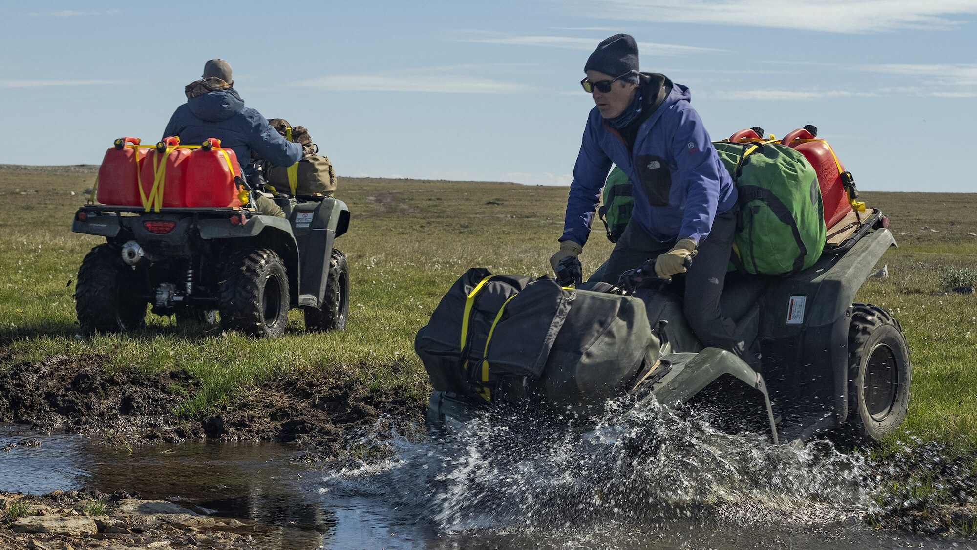 Explorer Mark Synnott rides his ATV into water during his journey in search of Sir John Franklin's lost tomb on King William Island, Nunavut, Canada. (National Geographic/Renan Ozturk)