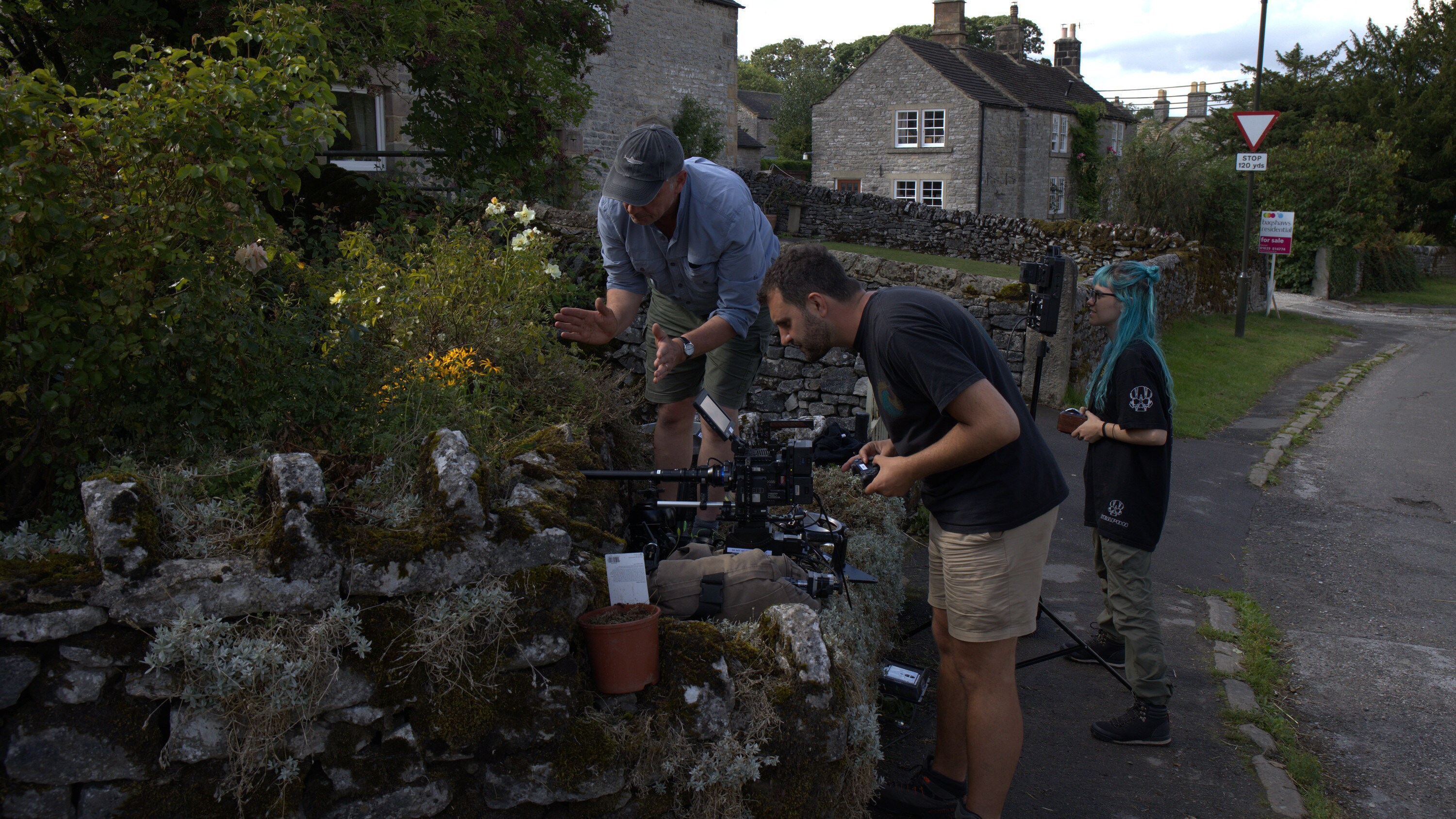 Assistant Producer Robert Harvey, camera operator Nick Widdop and focus puller Laura Pennafort film into a flower bed during a shoot for the "Once A Pond A Time" episode of "A Real Bug's Life." (National Geographic/James Scrivens)