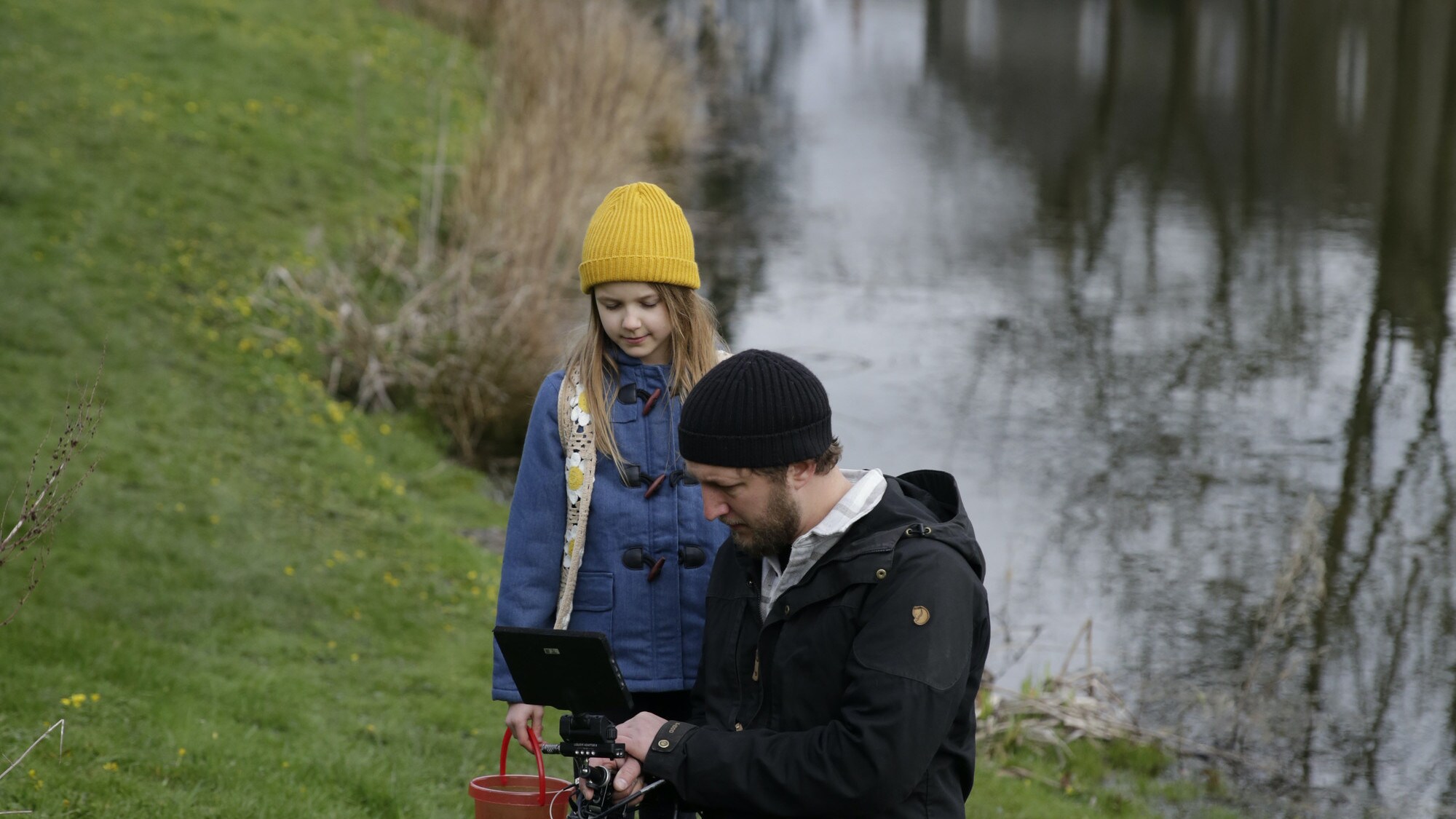 Director of Photography Chris Watts reviews footage of young actor Menna collecting frogspawn from the pond for the "Once A Pond A Time" episode of "A Real Bug's Life." (National Geographic/Matt Haworth)