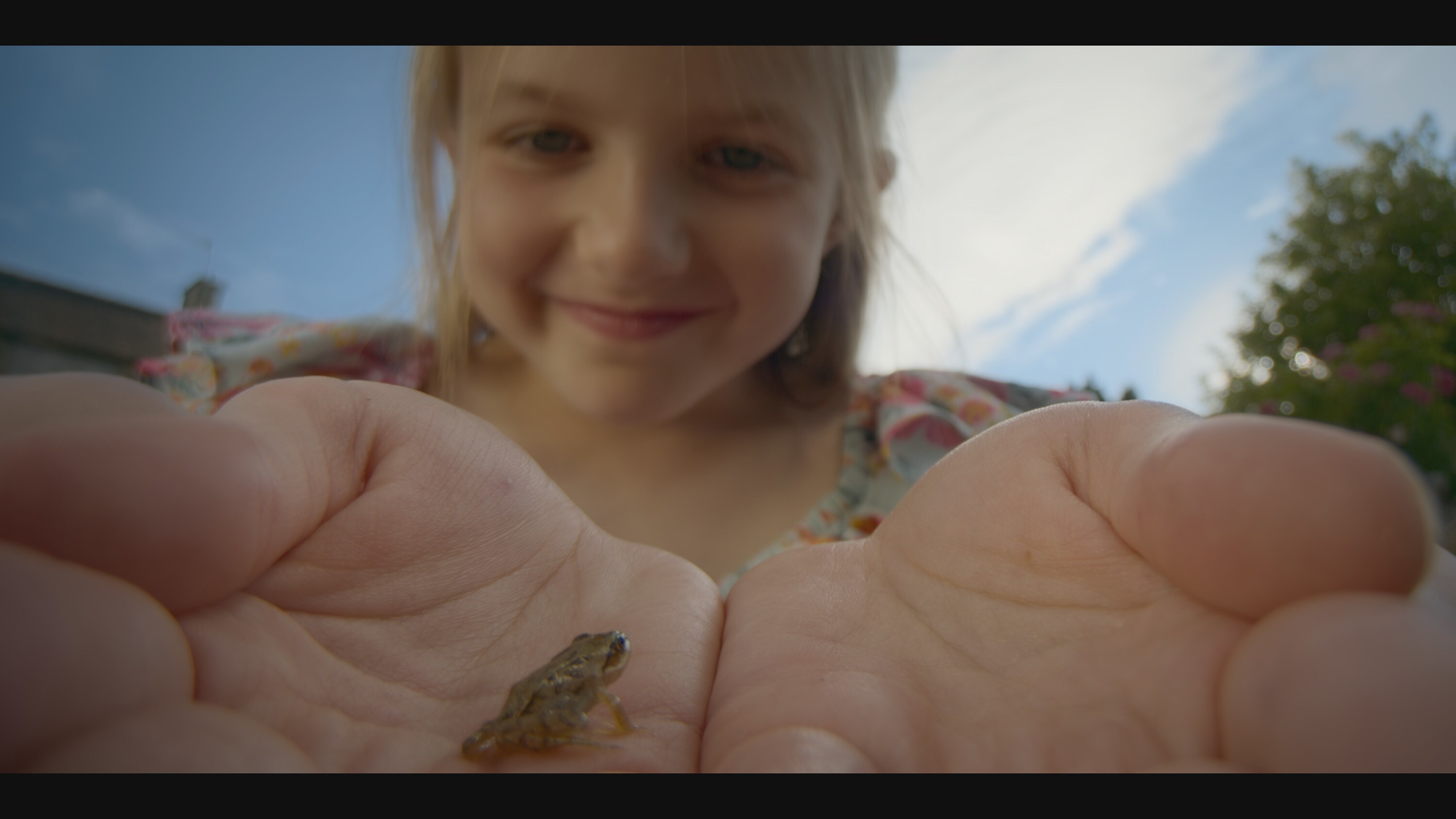 Young Menna holds a frog in her hands in the "Once A Pond A Time" episode of "A Real Bug's Life." (National Geographic)