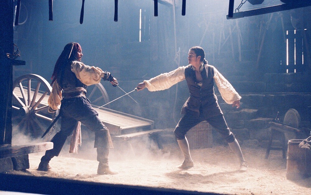 Actors Johnny Depp (Captain Jack Sparrow) and Orlando Bloom (William Turner) sword-fighting in the film "Pirates of the Caribbean"l