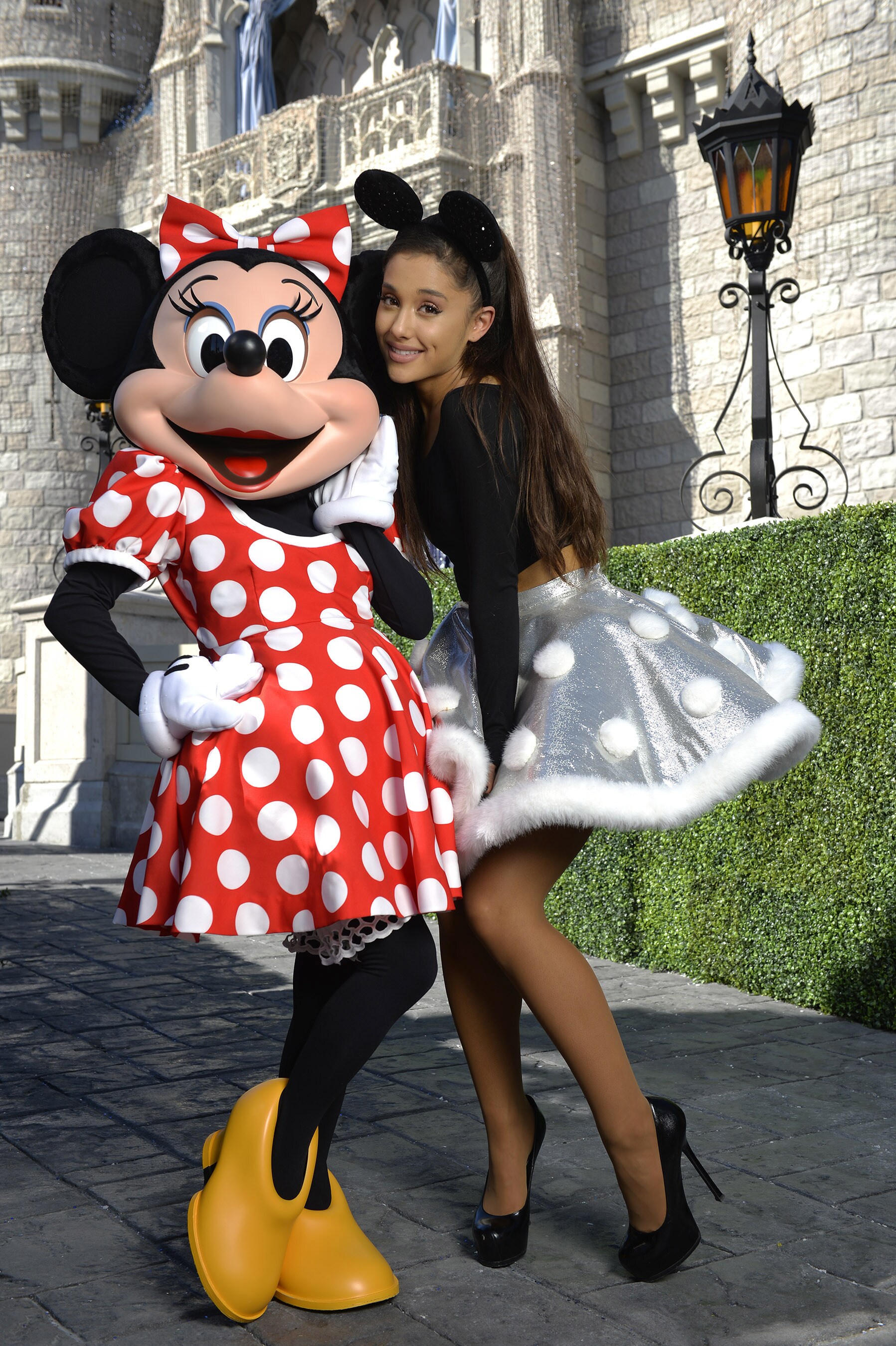 Ariana Grande poses Nov. 12, 2015 with Minnie Mouse during a break from taping the 'Disney Parks ...