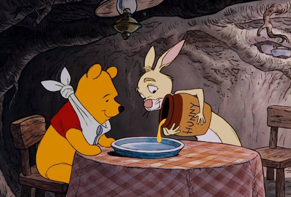 Rabbit pouring Winnie the Pooh some "hunny" onto a plate