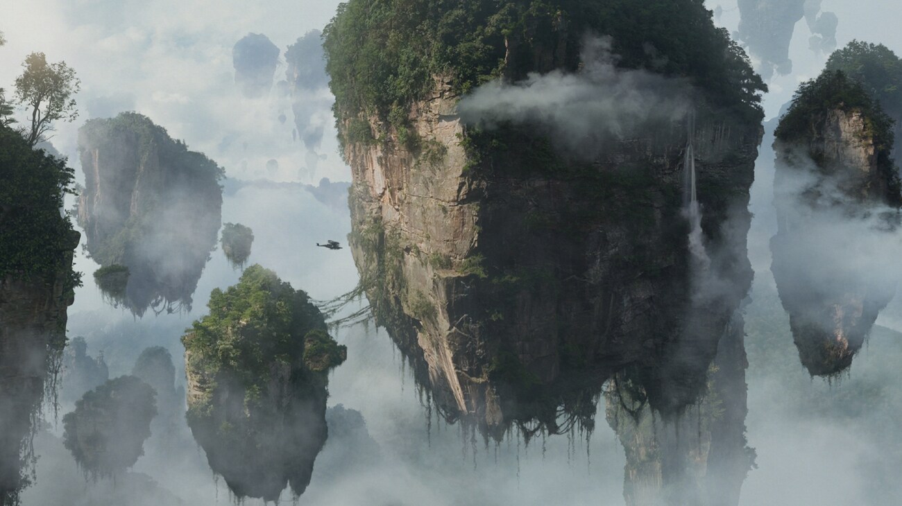 The Majestic Floating Hallelujah Mountains sit amongst the clouds, a Samson aircraft flies through them - seen from far away, the craft is tiny.