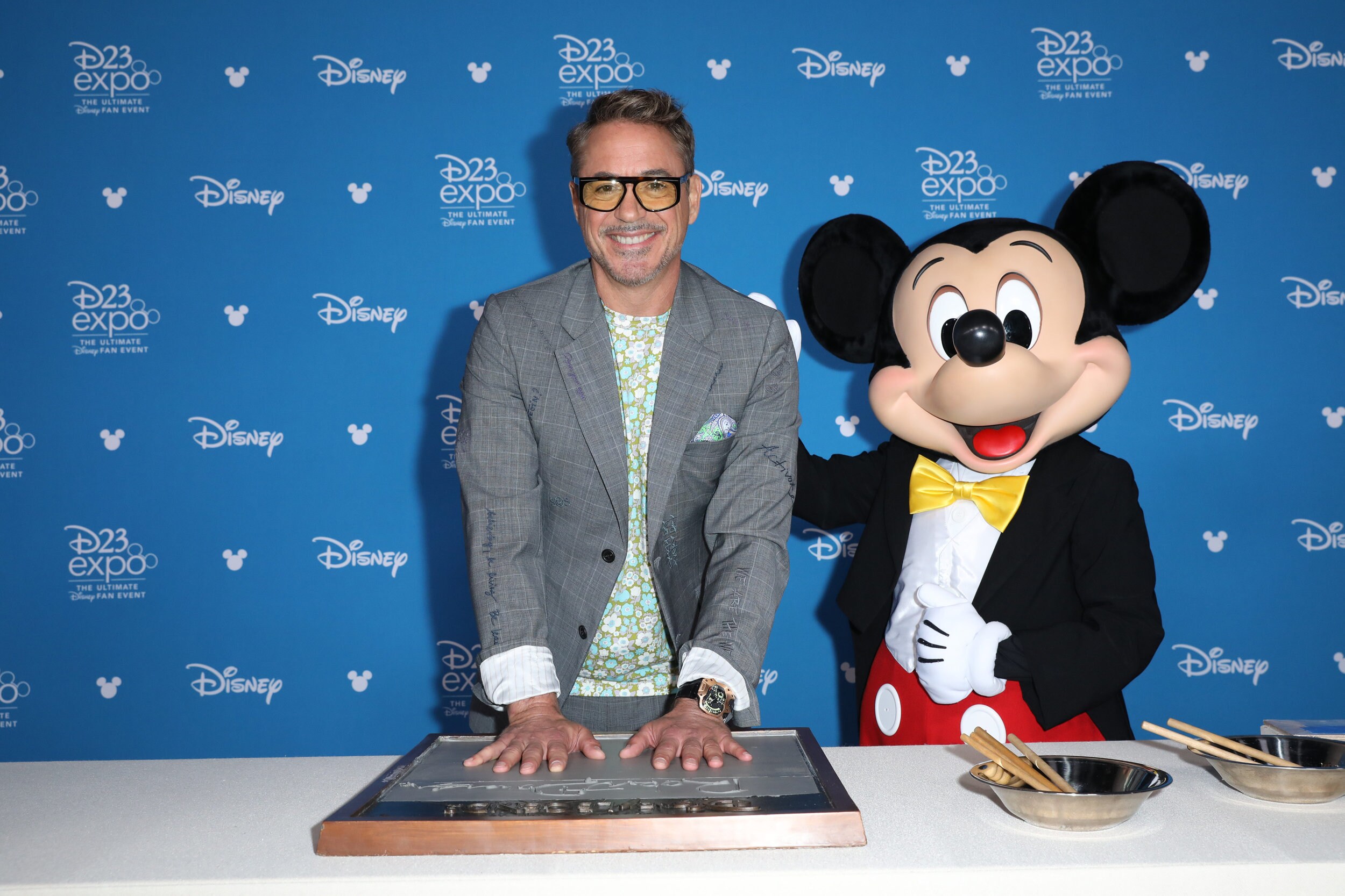 Robert Downey Jr. making his handprints with Mickey