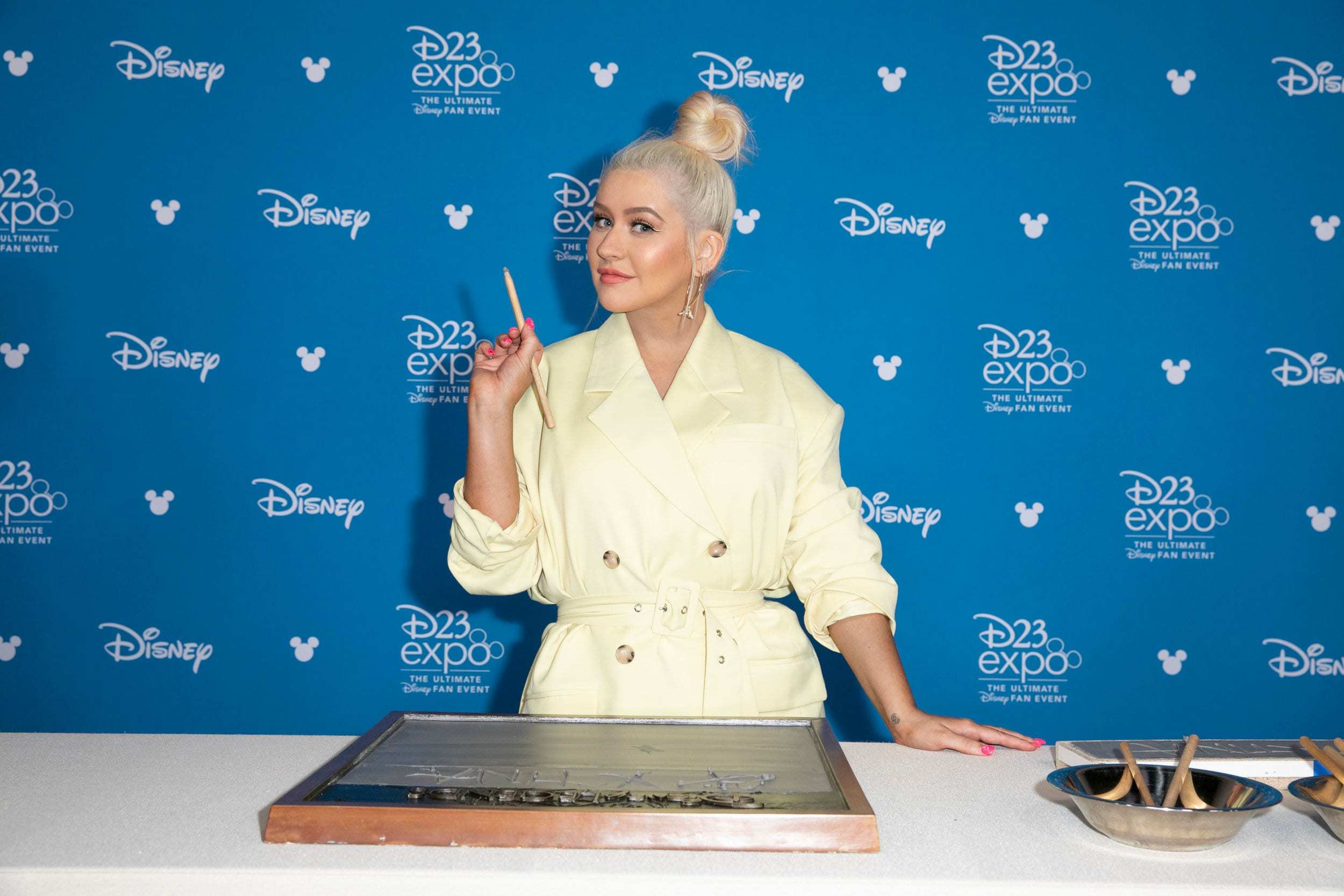 Christina Aguilera at the Disney Legends Awards autographing cement.