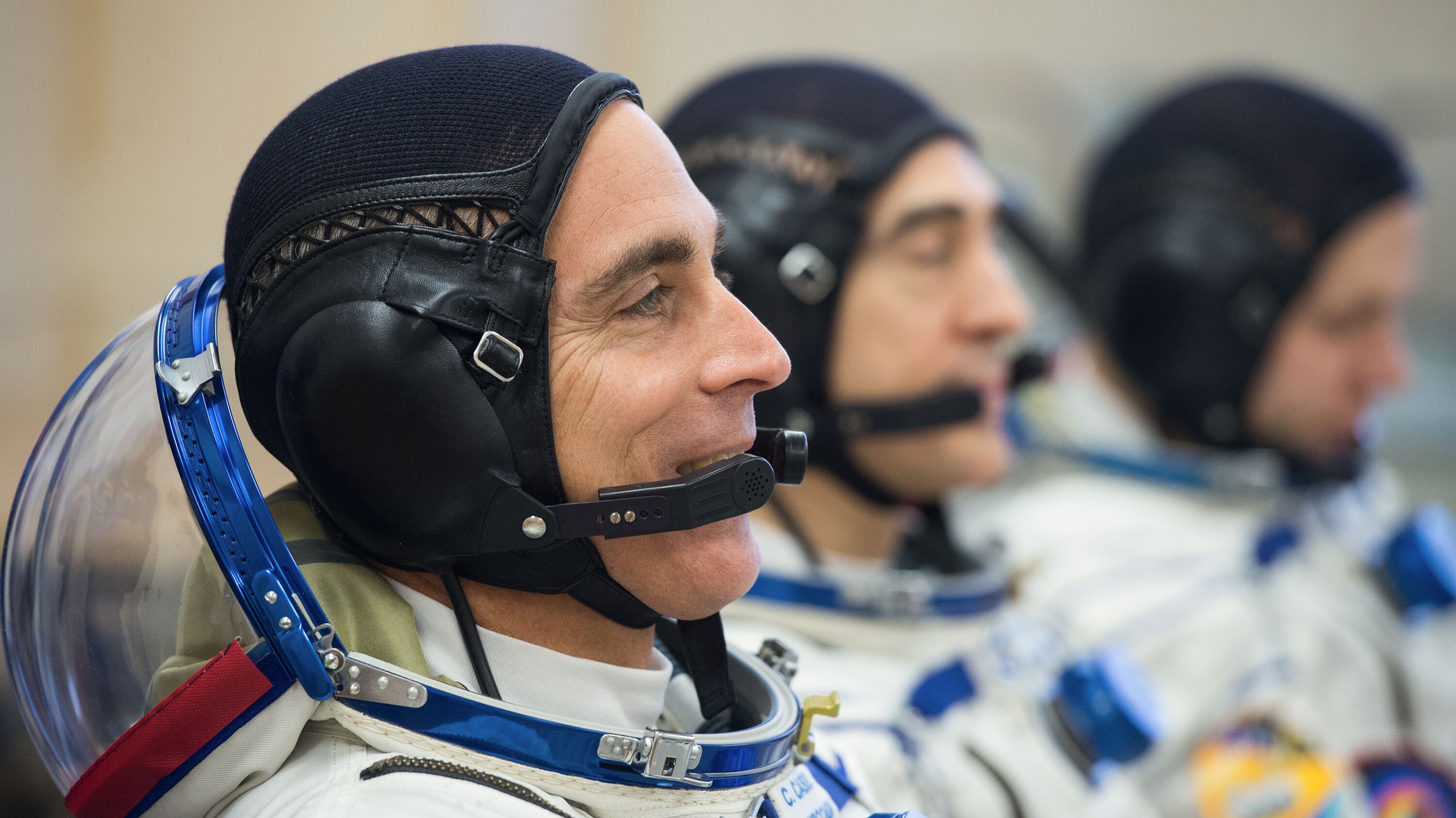 AMONG THE STARS - Expedition 63 crewmembers Chris Cassidy of NASA, left, Anatoly Ivanishin and Ivan Vagner of Roscosmos, right, talk to mission managers prior to departing for the launch pad, Thursday, April 9, 2020 at the Baikonur Cosmodrome in Kazakhstan. A few hours later, they lifted off on a Soyuz rocket for a six-and-a-half month mission on the International Space Station. (NASA/GCTC/Andrey Shelepin) CHRIS CASSIDY