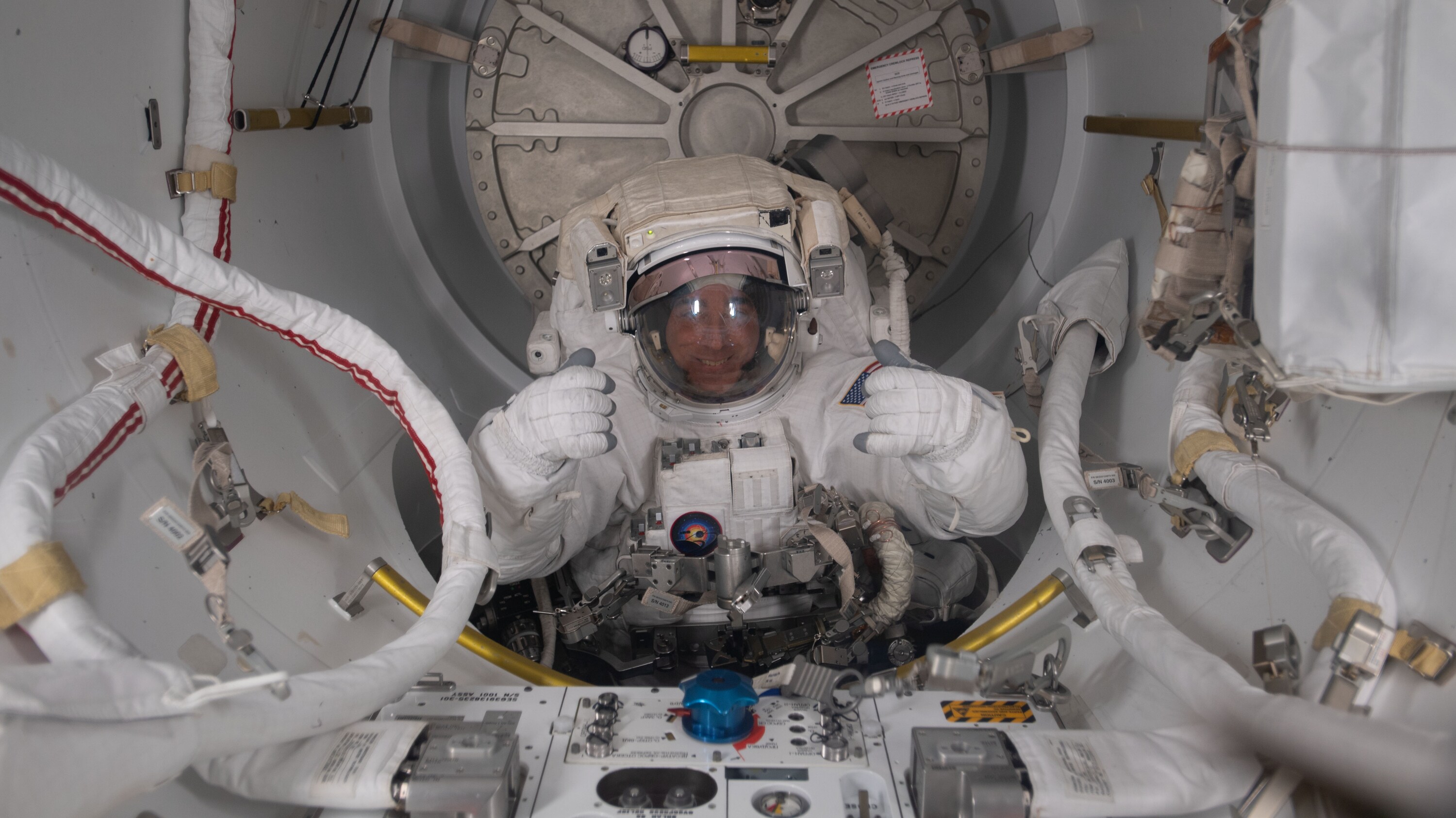 AMONG THE STARS - (July 1, 2020) - NASA astronaut and Expedition 63 Commander is pictured in his U.S. spacesuit halfway inside the crew lock portion of the Quest airlock during a spacewalk to replace batteries on the International Space Station's Starboard-6 truss structure. (NASA) CHRIS CASSIDY