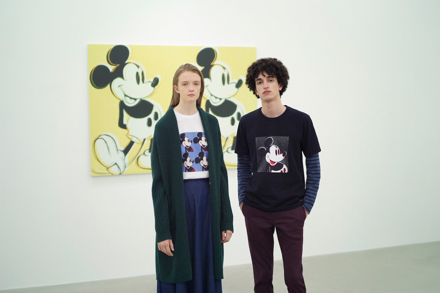 Models in art gallery, wearing clothes with Mickey Mouse prints from Andy Warhol's pop art piece 