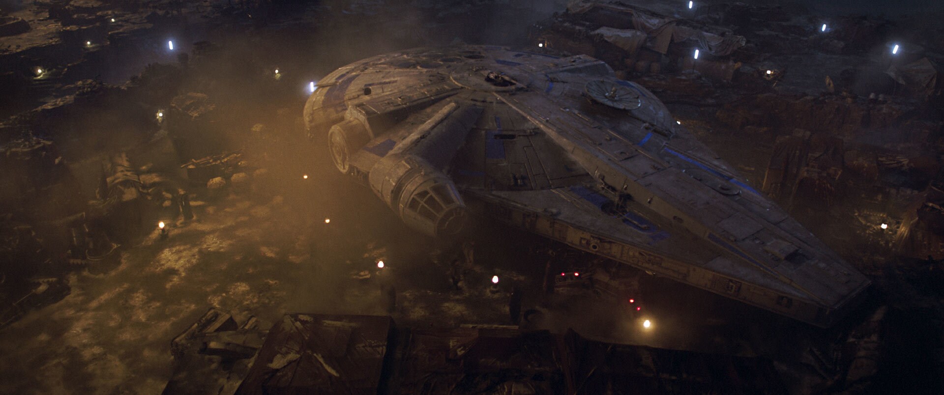 Outside, at one of the lodge’s landing pads, sits the Millennium Falcon, a Corellian YT-1300 frei...