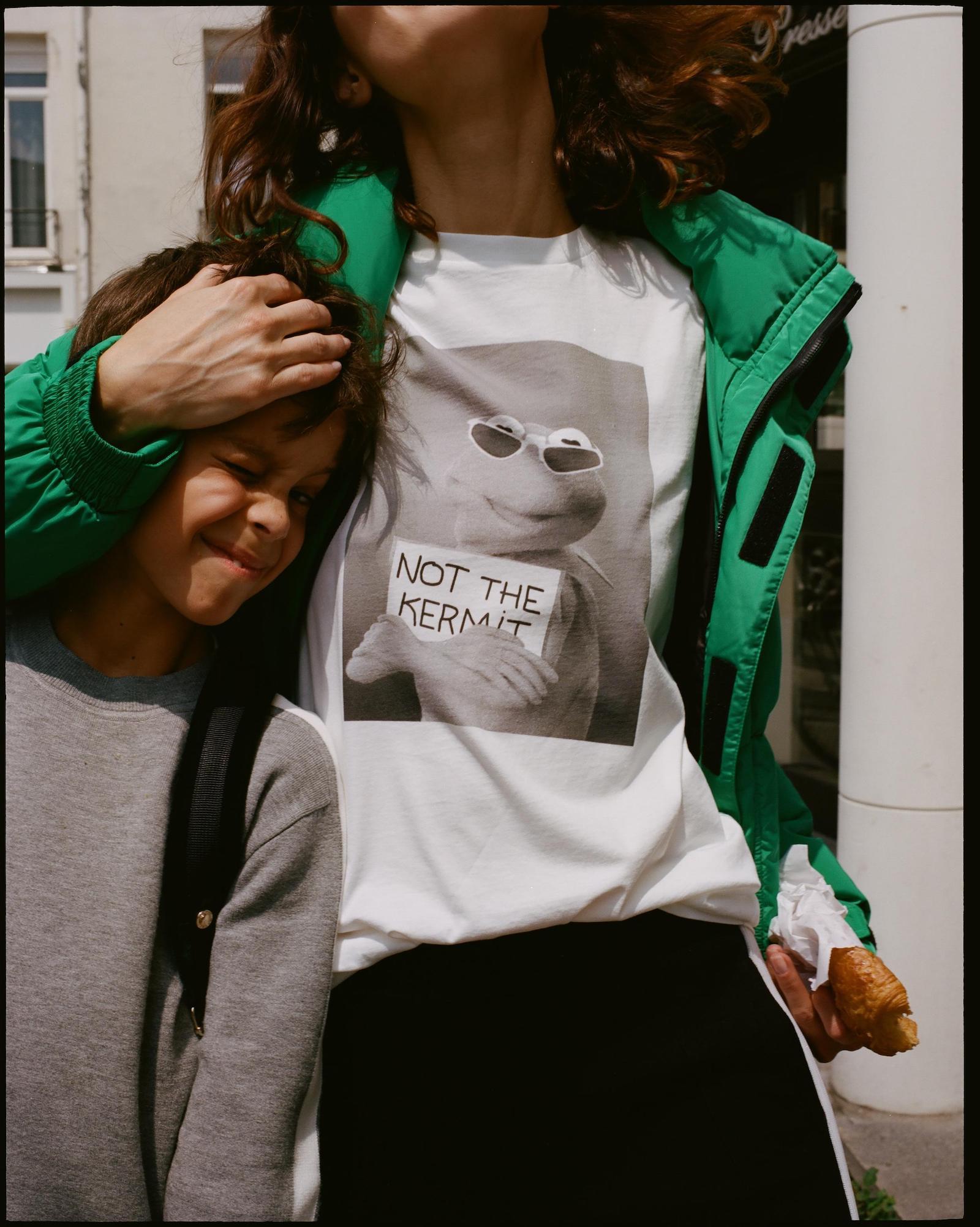 Model wearing white tee shirt featuring Kermit from the Sandro collection