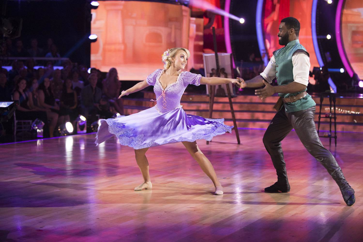 Evanna Lynch and Keo Motsepe dancing, dressed up as Rapunzel and Flynn Rider from Tangled