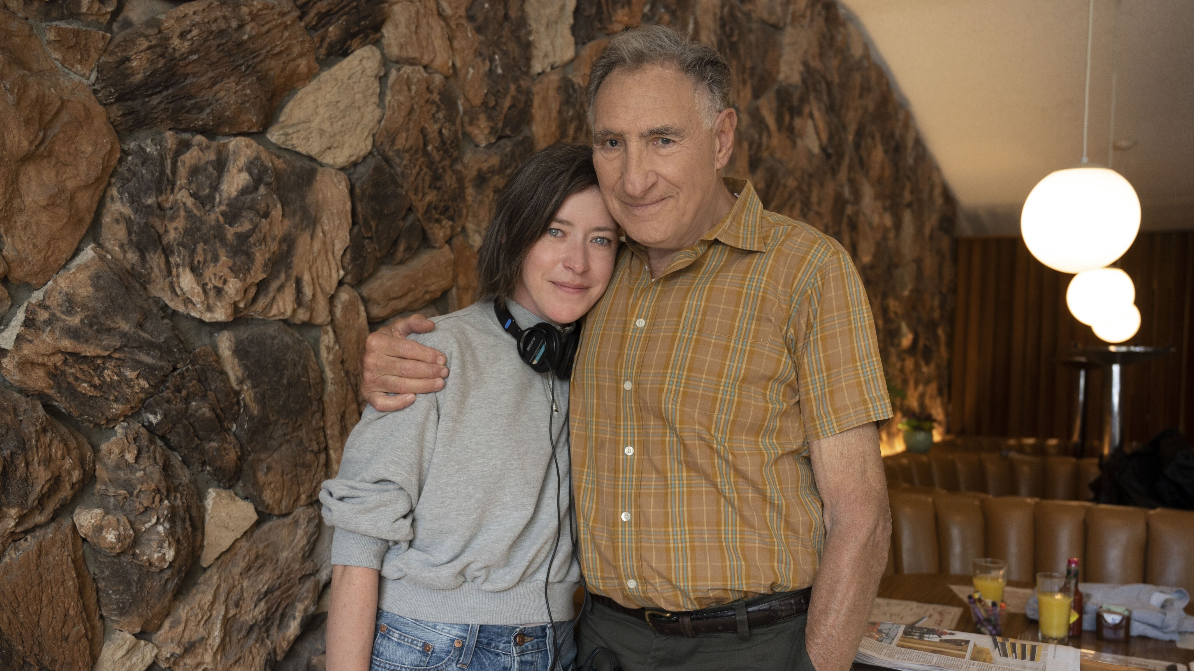 (L-R): Director Julia Hart and Judd Hirsch as Mr. Mitchell behind the scenes of Disney's live-action HOLLYWOOD STARGIRL, exclusively on Disney+. Photo by Suzanne Tenner. © 2022 Disney Enterprises, Inc. All Rights Reserved.