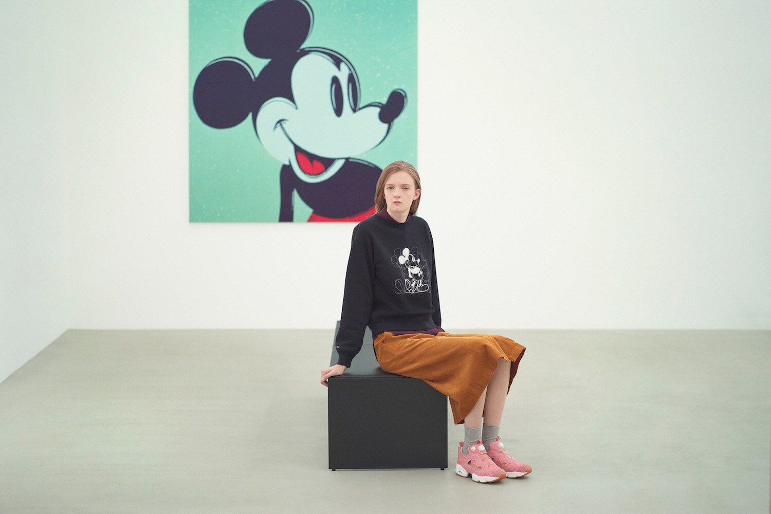 Model wearing a black jumper with Andy Warhol's pop artwork