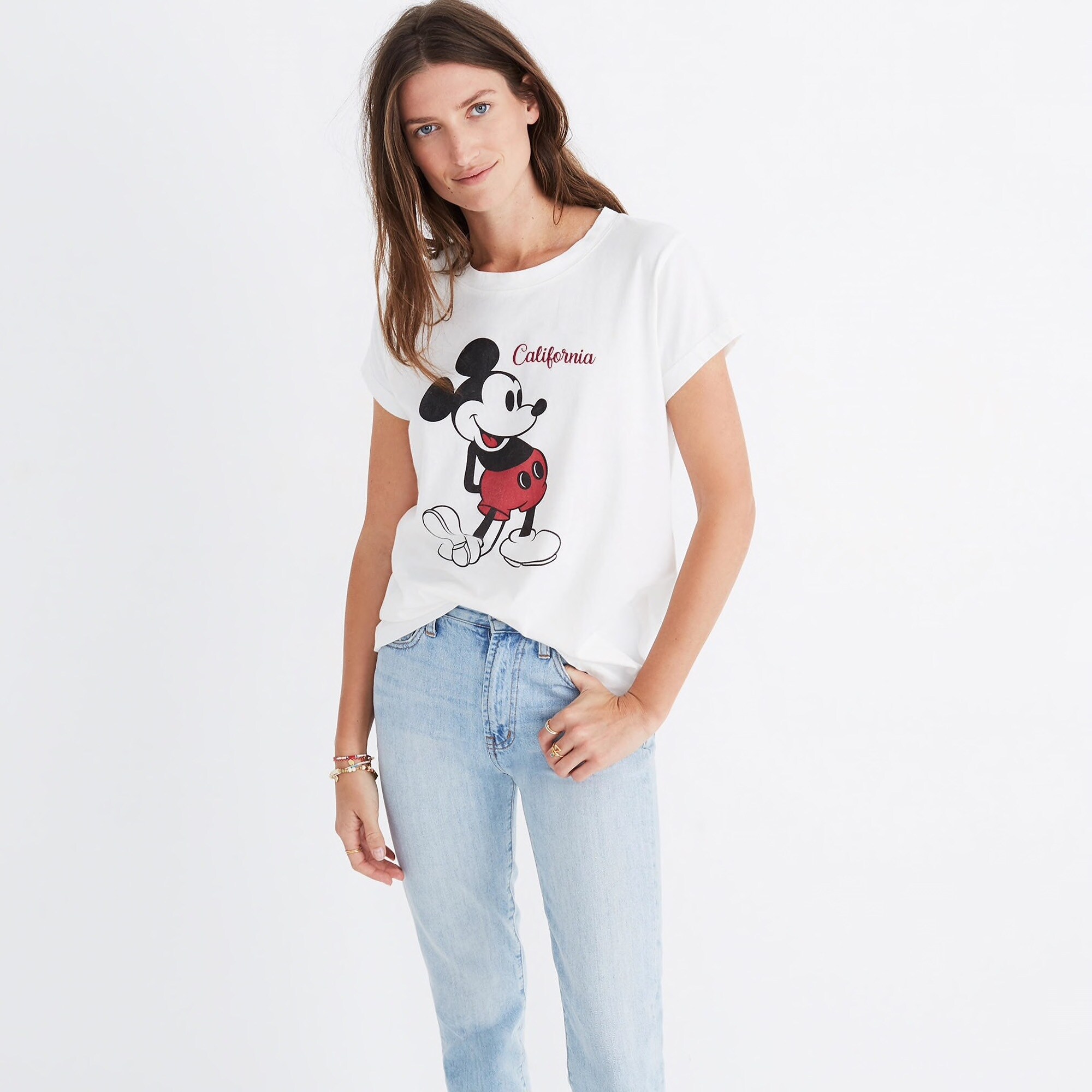 Image of WOMEN'S FASHION, 1970s. - A Young Woman Wearing A T-shirt With  Mickey Mouse Design, Denim Blue Jeans With Various Patches, And Sandals,  Probably In Southern California, Early 1970s. From Granger 