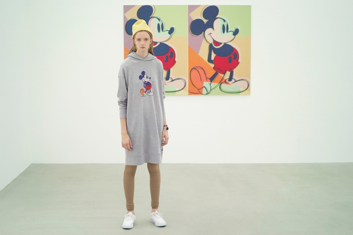 Model wearing a long hoodie featuring Andy Warhol's pop artwork