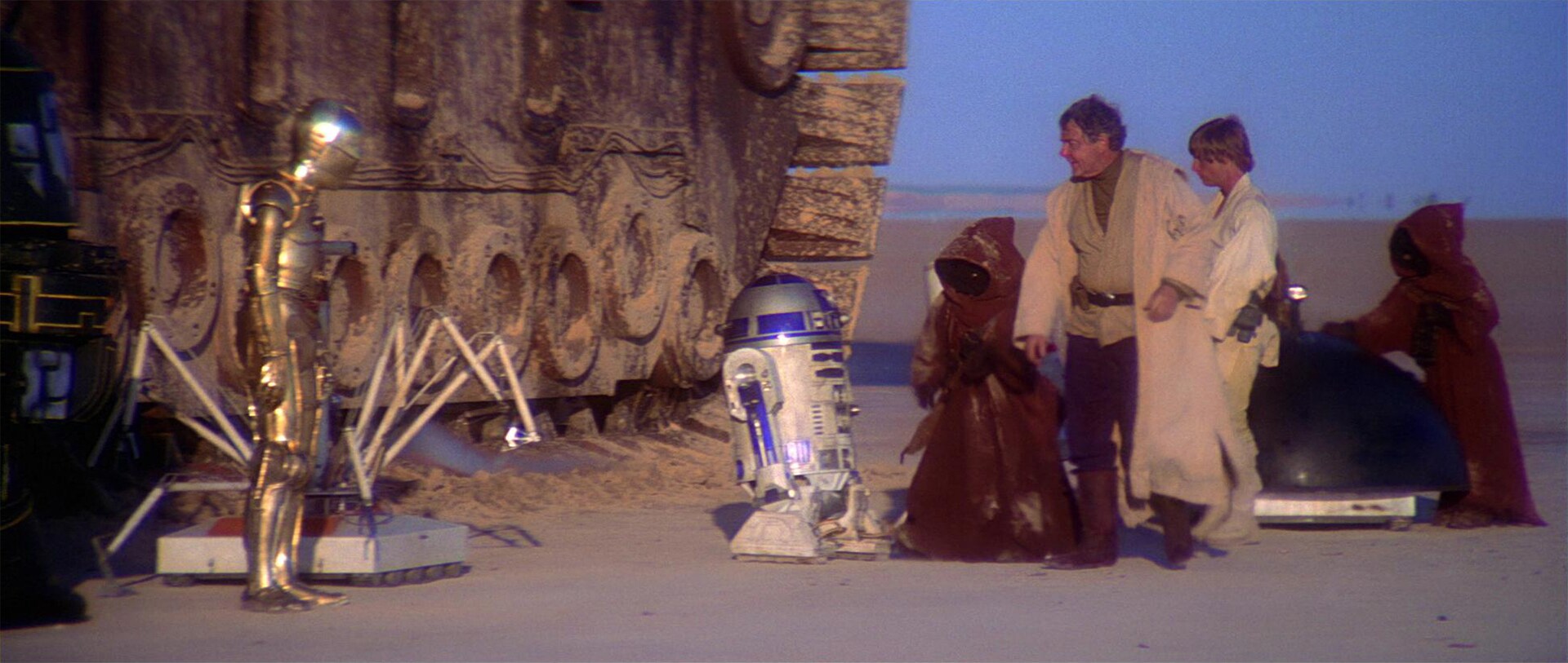 Uncle Owen reviews the droids for sale.