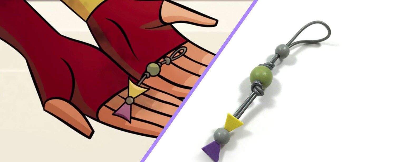 Ahsoka Tano holds the silka beads in Star Wars Forces of Destiny, alongside a completed silka bead craft.