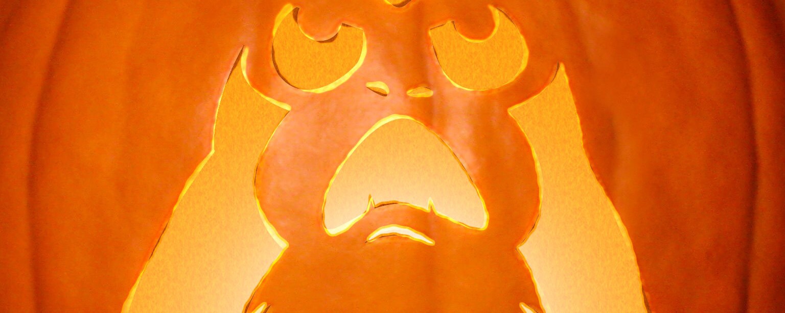 A screaming porg carved into a pumpkin and illuminated from within.
