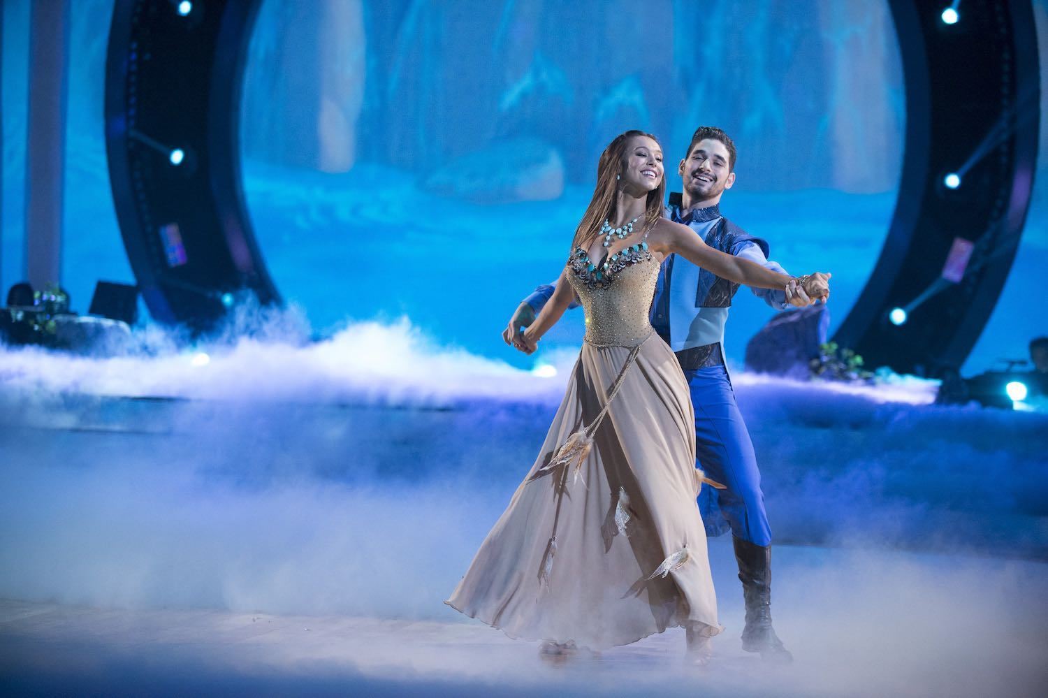 Alexis Ren and Alan Bersten dancing, dressed as Pocahantas and John Smith from Pocahontas