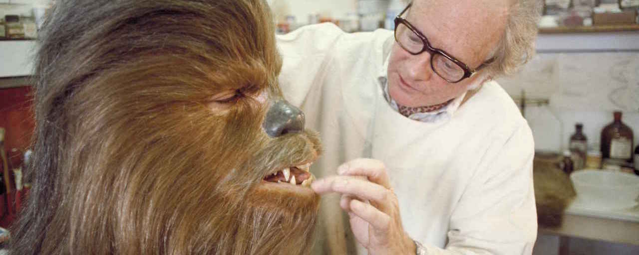 Makeup artist Stuart Freeborn touches up Chewbacca.