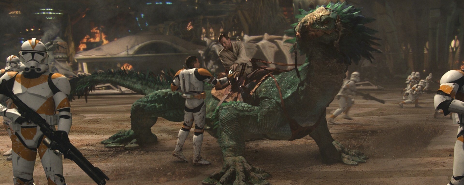 Obi-Wan Kenobi sits saddled on the back of Boga, a female varactyl in Star Wars: Revenge of the Sith. Boga is a wingless lizard used for transport and has pebbled skin with a greenish-blue sheen and a crown of richly colored feathers fringing her head and neck.