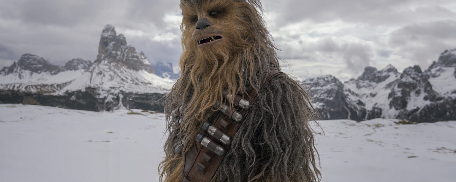 Chewbacca on the snowy, mountainous planet of Vandor in Solo: A Star Wars Story.