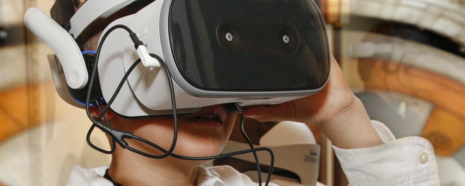A child wears a Starlight Xperience virtual reality headset.