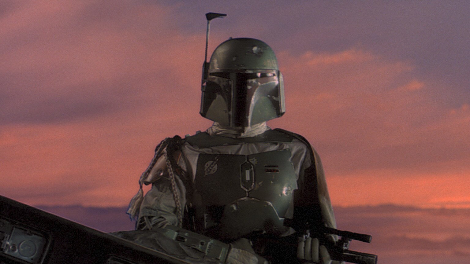 Boba Fett watches as Han is loaded into the Slave I in Star Wars: The Empire Strikes Back.