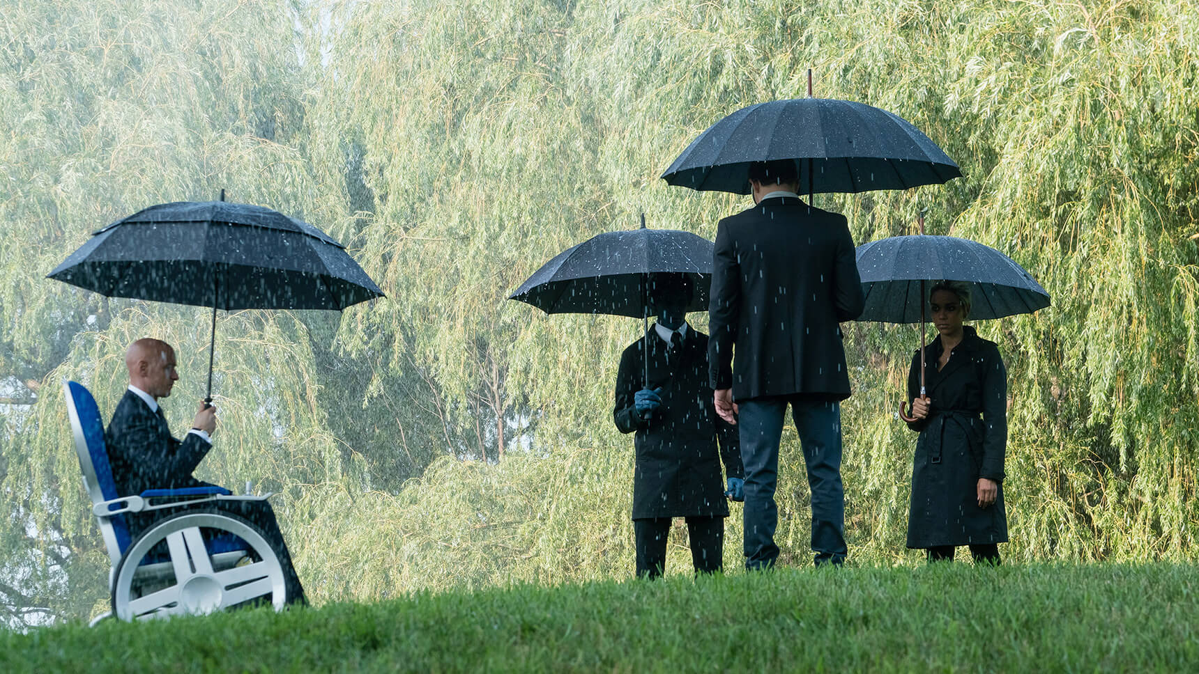 X-Men standing in the rain with umbrellas in the movie "X-Men: Dark Phoenix"