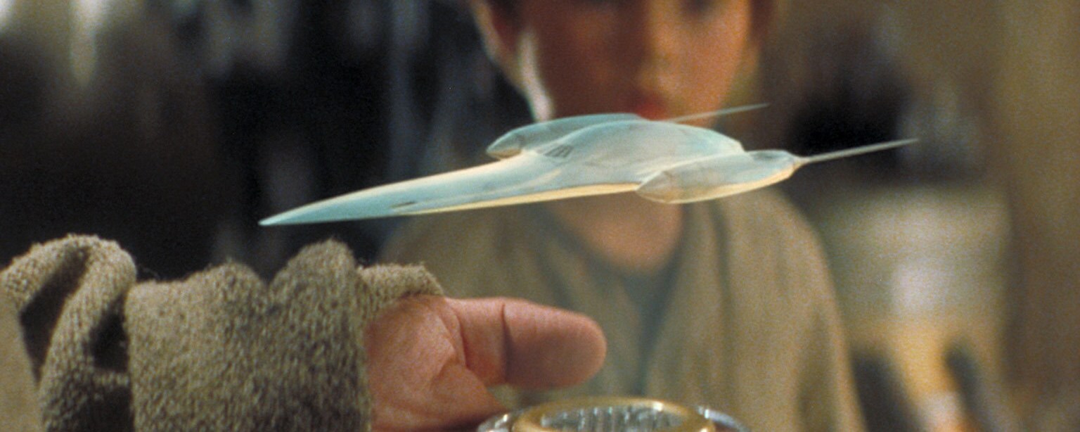 Anakin Skywalker looks at a holoprojector.