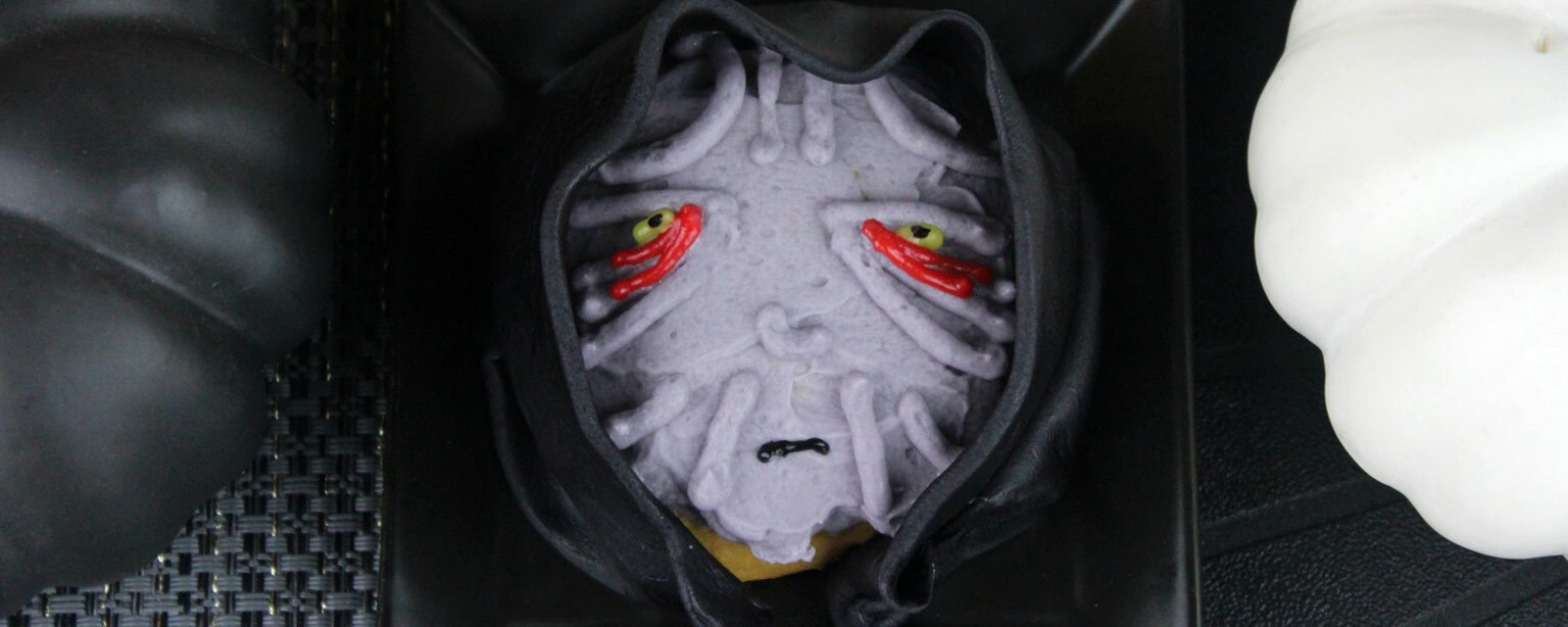 Palpatine's cloaked face rendered in icing and fondant, on a pumpkin spice cookie.