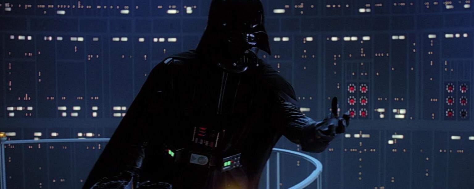 Darth Vader holds out his hand to Luke.