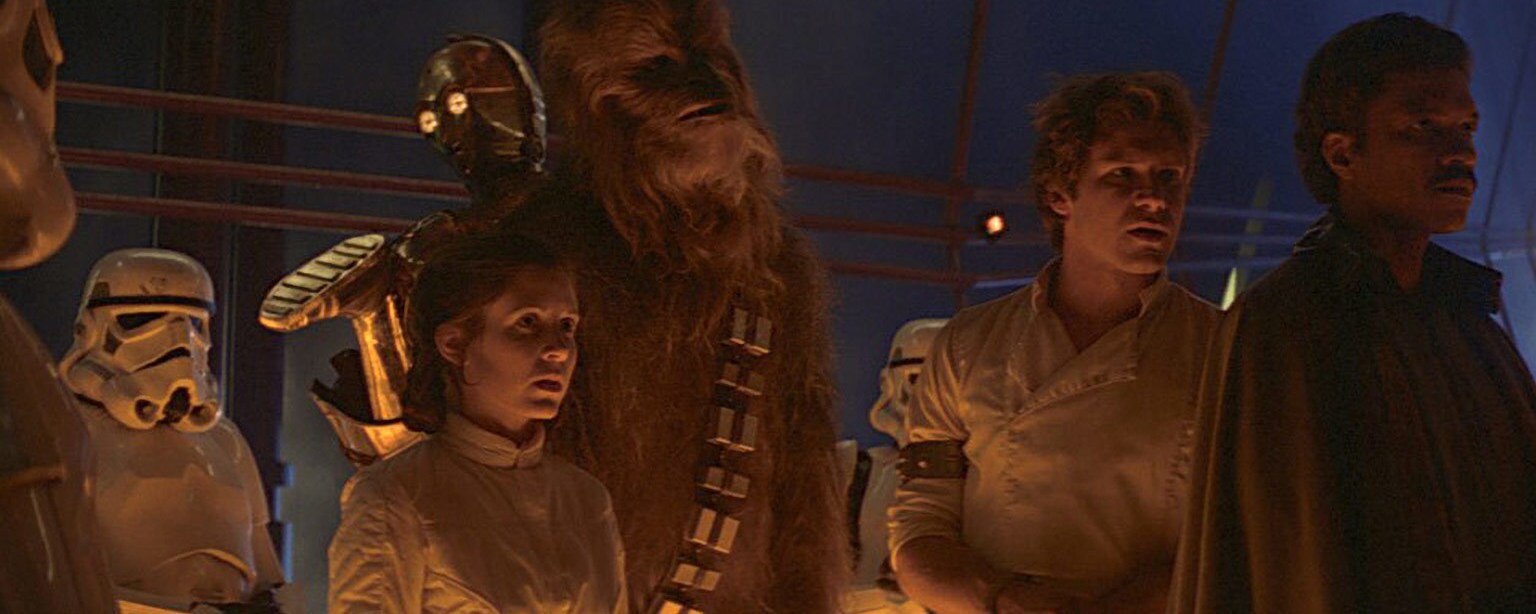 Leia, Chewie, Han, Lando, C-3PO, and stormtroopers in The Empire Strikes Back.