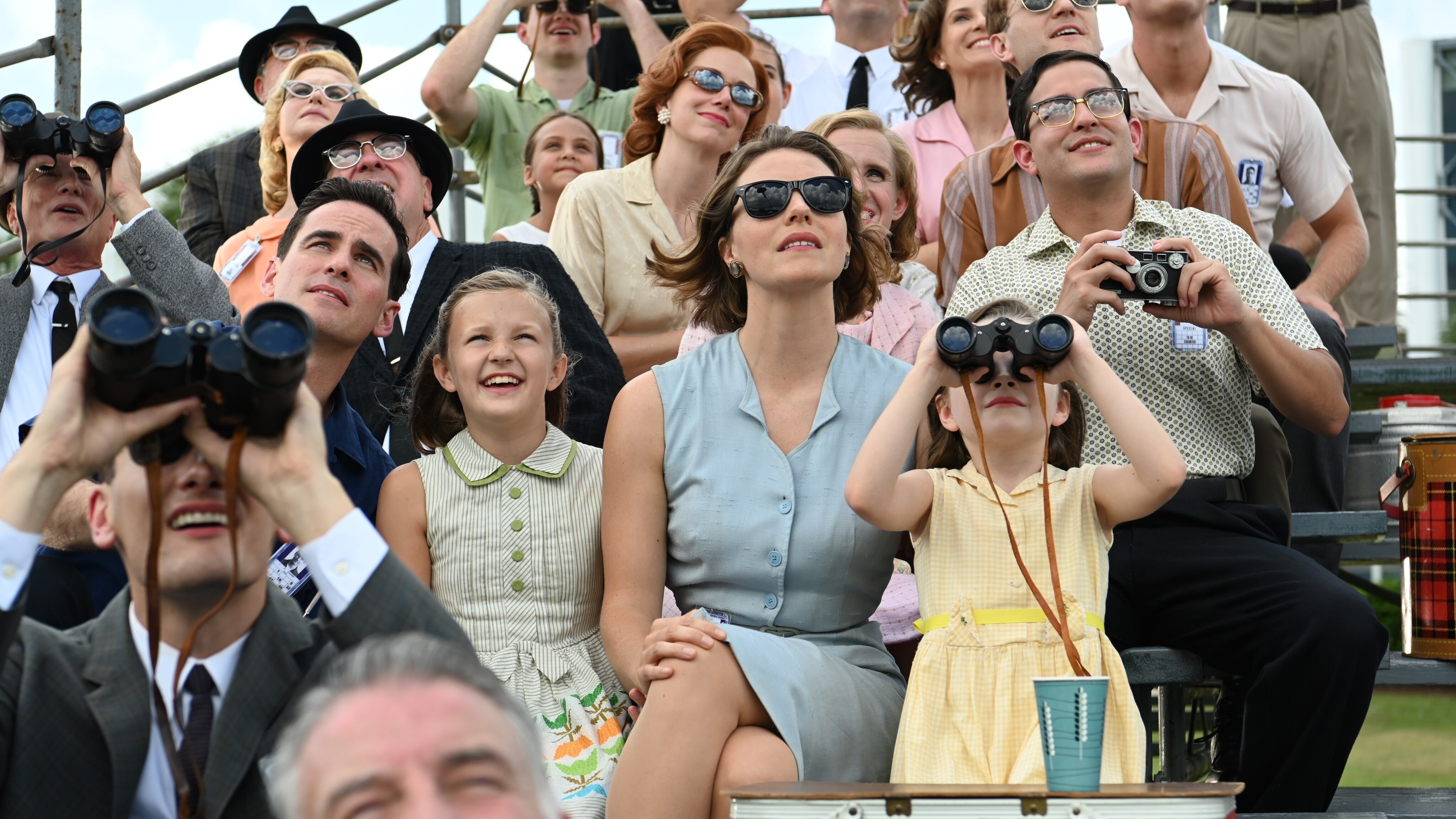 Gordon Cooper played by Colin O’Donoghue and Trudy Cooper played by Eloise Mumford sit with their daughters watching the launch of a test rocket in National Geographic's THE RIGHT STUFF streaming on Disney+. (National Geographic/Gene Page)