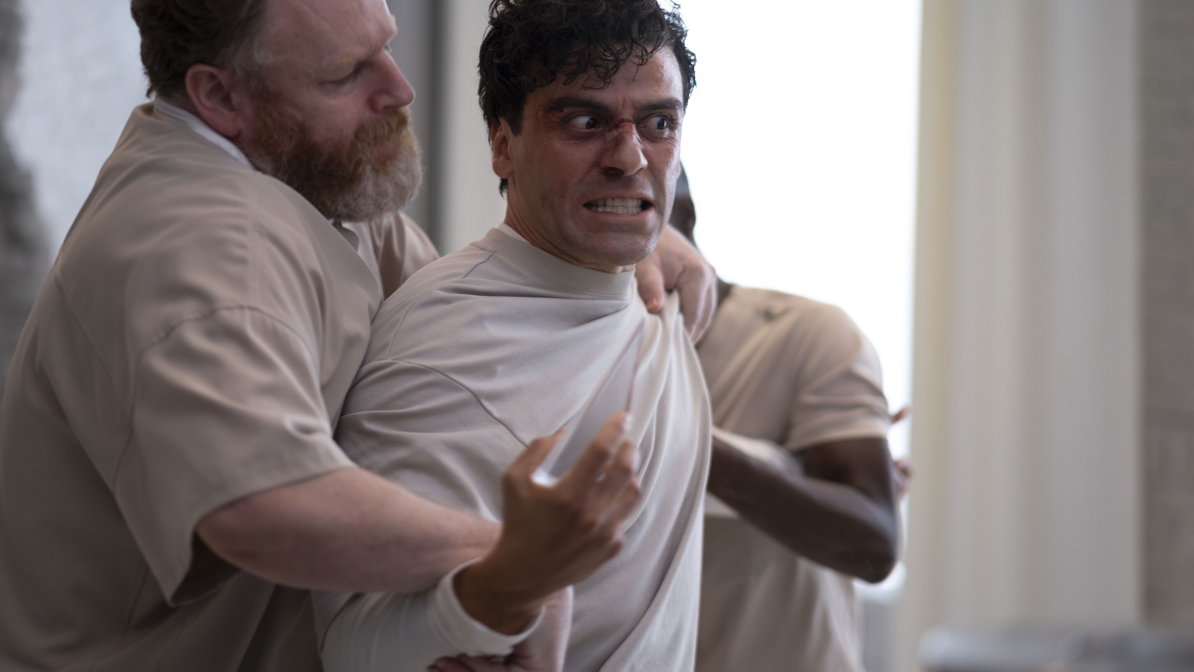 (L-R): David Ganly as Billy Fitzgerald, Oscar Isaac as Marc Spector/Steven Grant, and Ann Akin as Bobbi Kennedy in Marvel Studios' MOON KNIGHT, exclusively on Disney+. Photo by Gabor Kotchy. ©Marvel Studios 2022. All Rights Reserved.