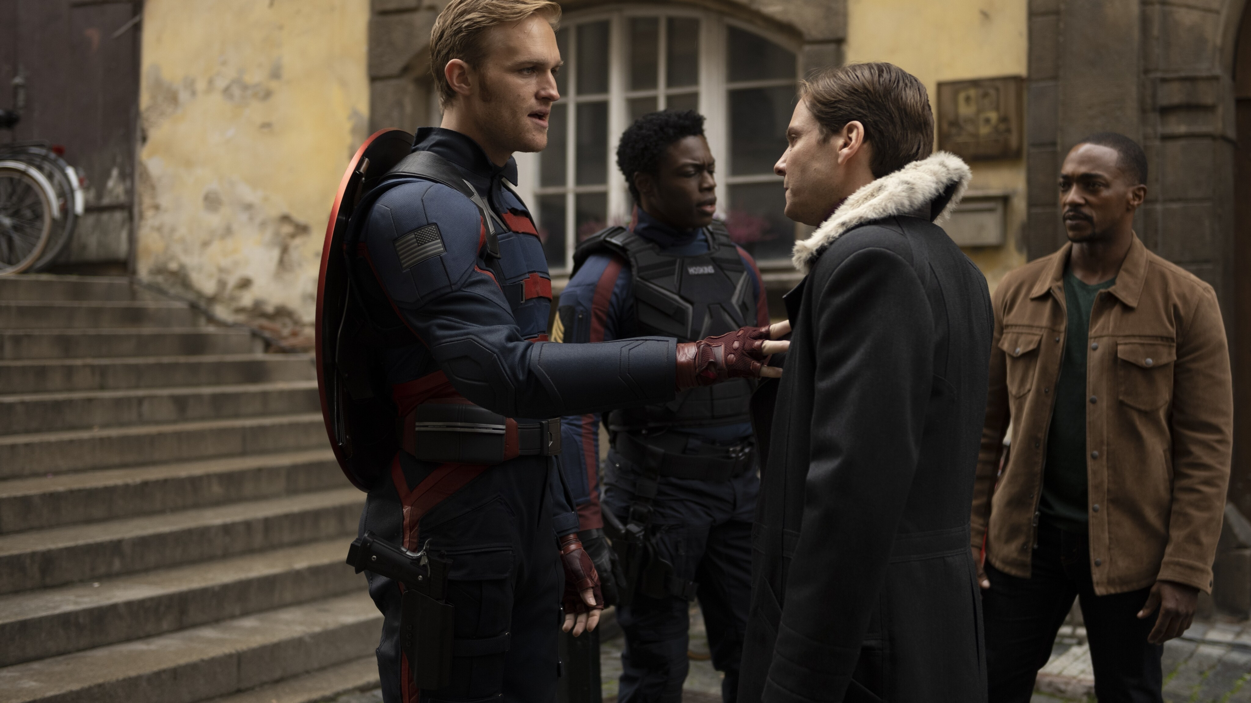(L-R): John Walker (Wyatt Russell), Lemar Hoskins (Clé Bennett), Zemo (Daniel Brühl) and Falcon/Sam Wilson (Anthony Mackie) in Marvel Studios' THE FALCON AND THE WINTER SOLDIER exclusively on Disney+. Photo by Julie Vrabelová. ©Marvel Studios 2021. All Rights Reserved.