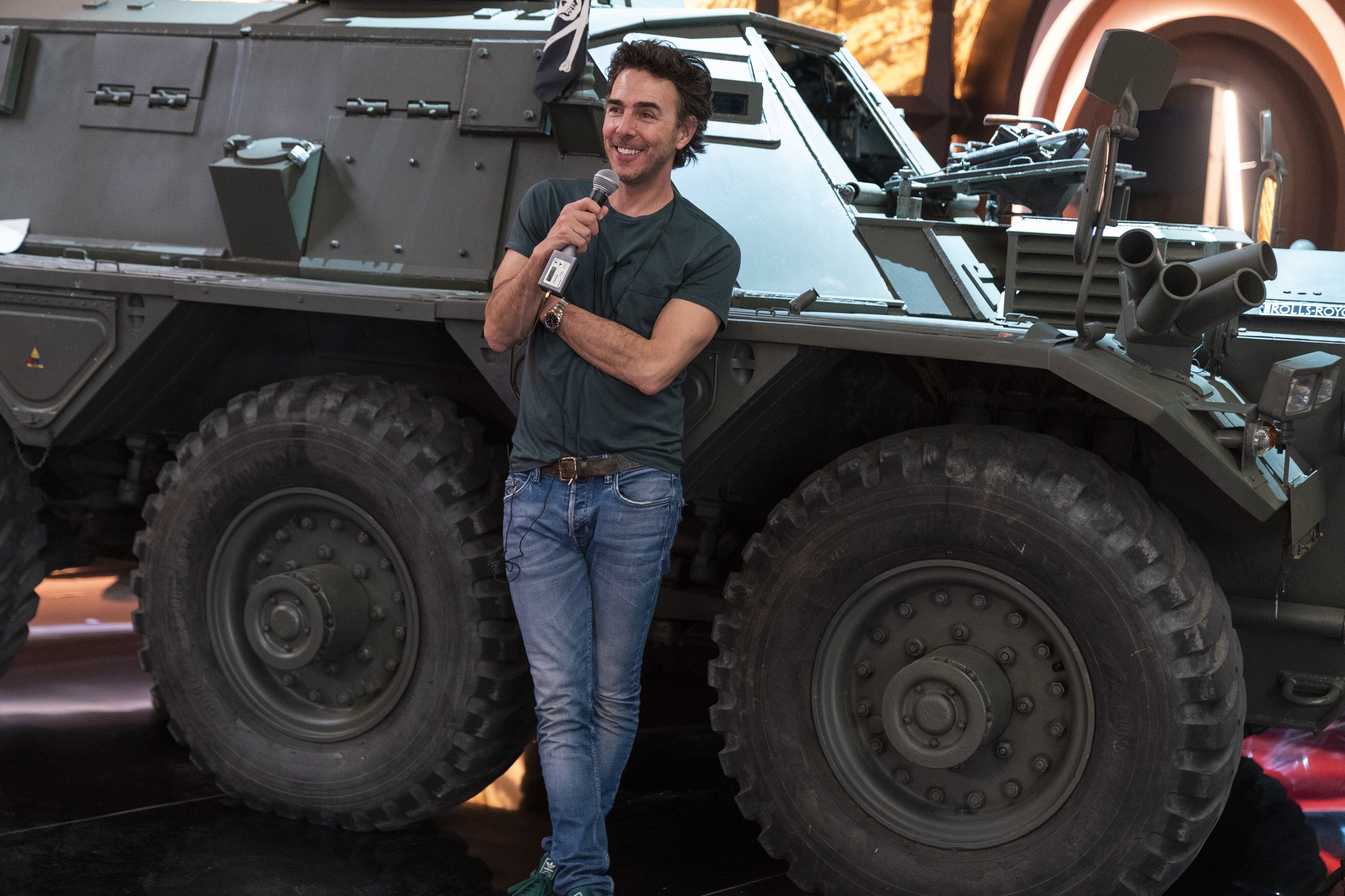 Free Guy Director Shawn Levy leans up against a large car on set